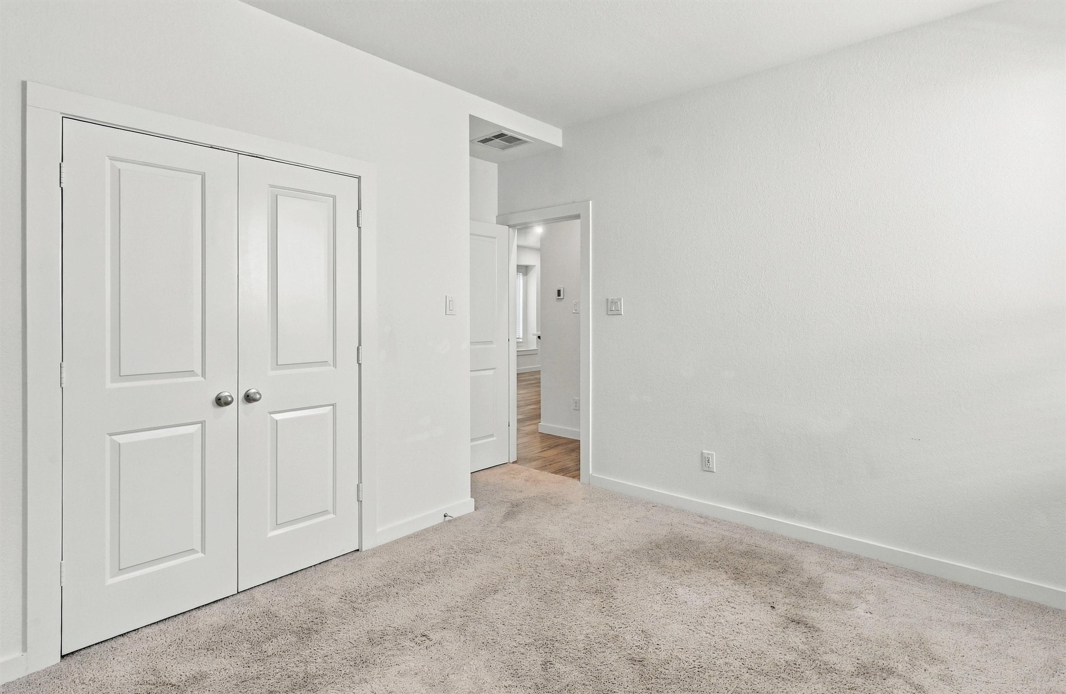 Second bedroom, features carpet and large closet.