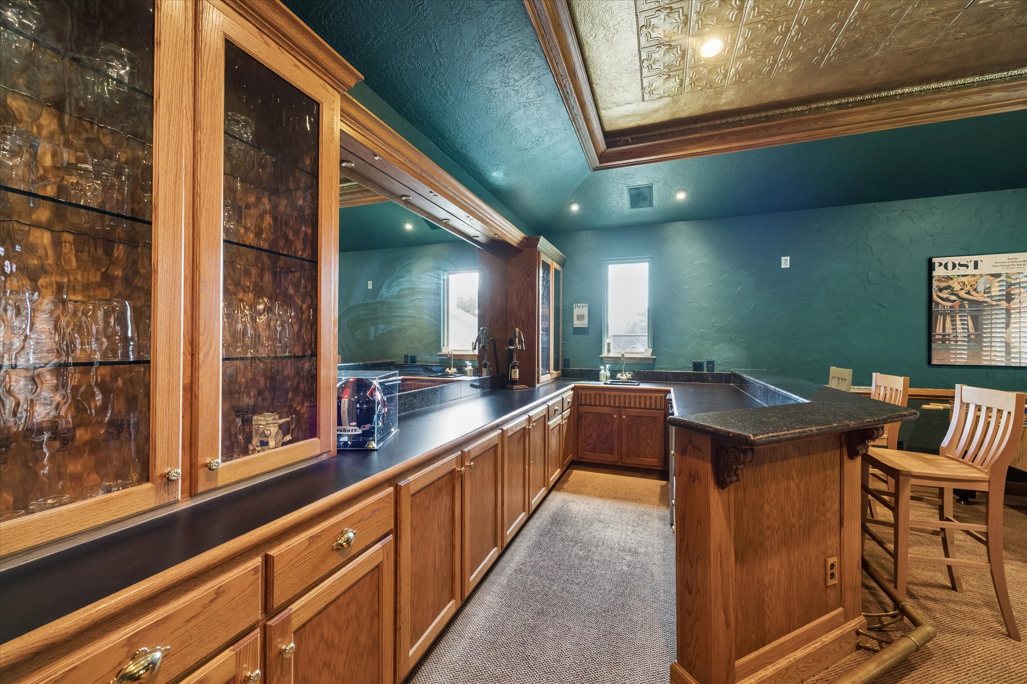 No need to miss a moment of the fun! With a custom wet bar, extensive cabinetry, and plenty of counter space, everything you need to keep guests refreshed is right where the action happens.
