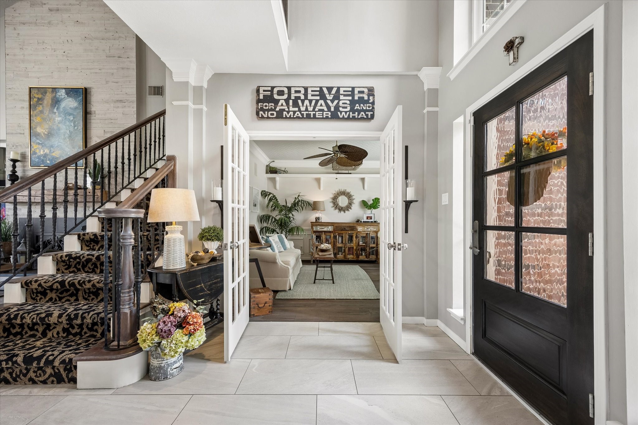 From the moment you step inside, soaring ceilings, a graceful staircase, and beautiful architectural details create an inviting first impression. A welcoming introduction to a home filled with character and custom touches.