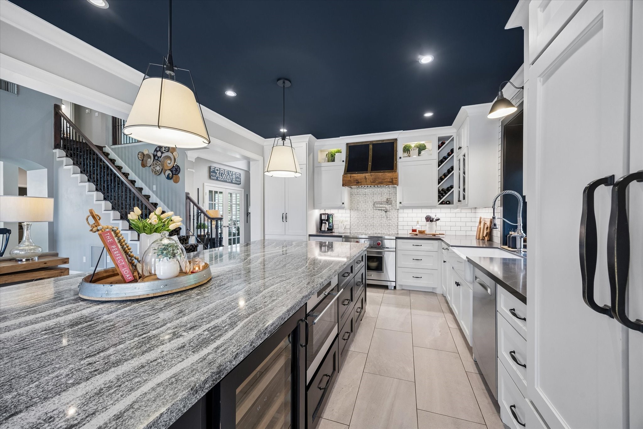 Imagine preparing your favorite meal while still being part of the conversation in the family room. The kitchen's thoughtful layout, beautiful finishes, and open connection to the living spaces make entertaining feel effortless.