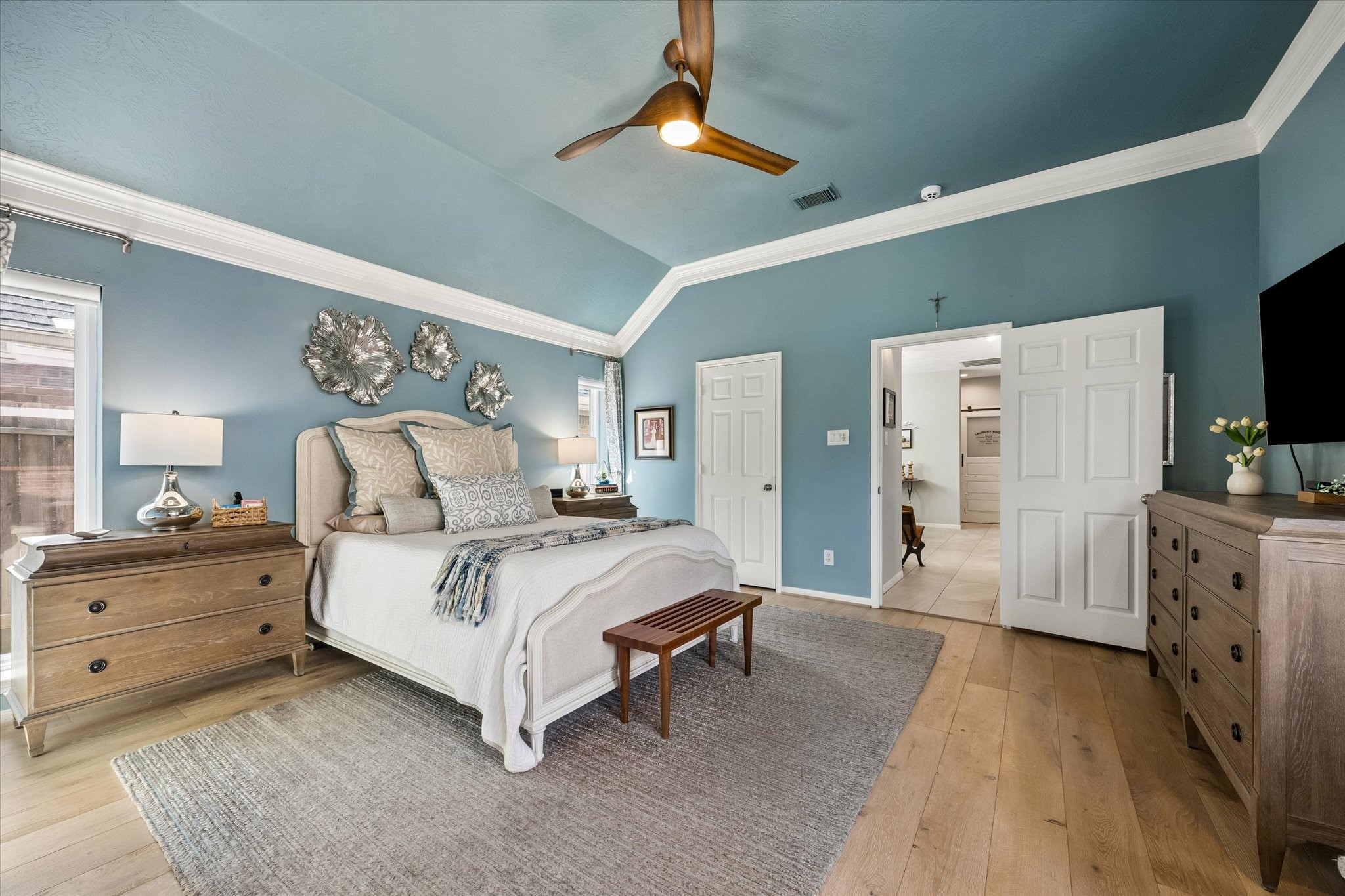 Imagine waking up without feeling rushed, enjoying a little quiet time before the day begins. This spacious primary bedroom offers room for comfortable furnishings and a relaxing atmosphere that feels like your own private escape.