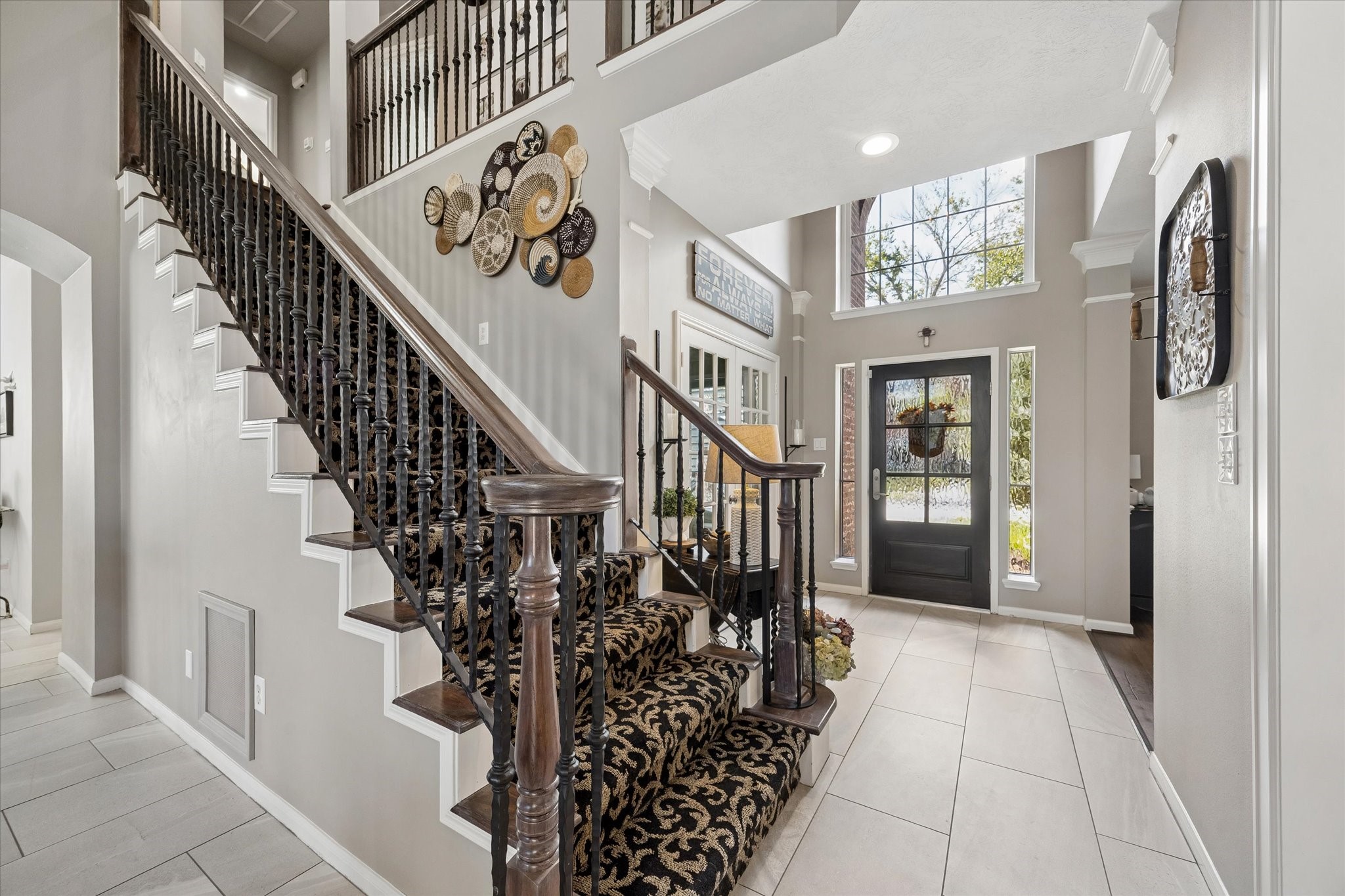 The sweeping staircase and open entry create a memorable focal point, bringing together the home's beautiful architectural details and inviting atmosphere.