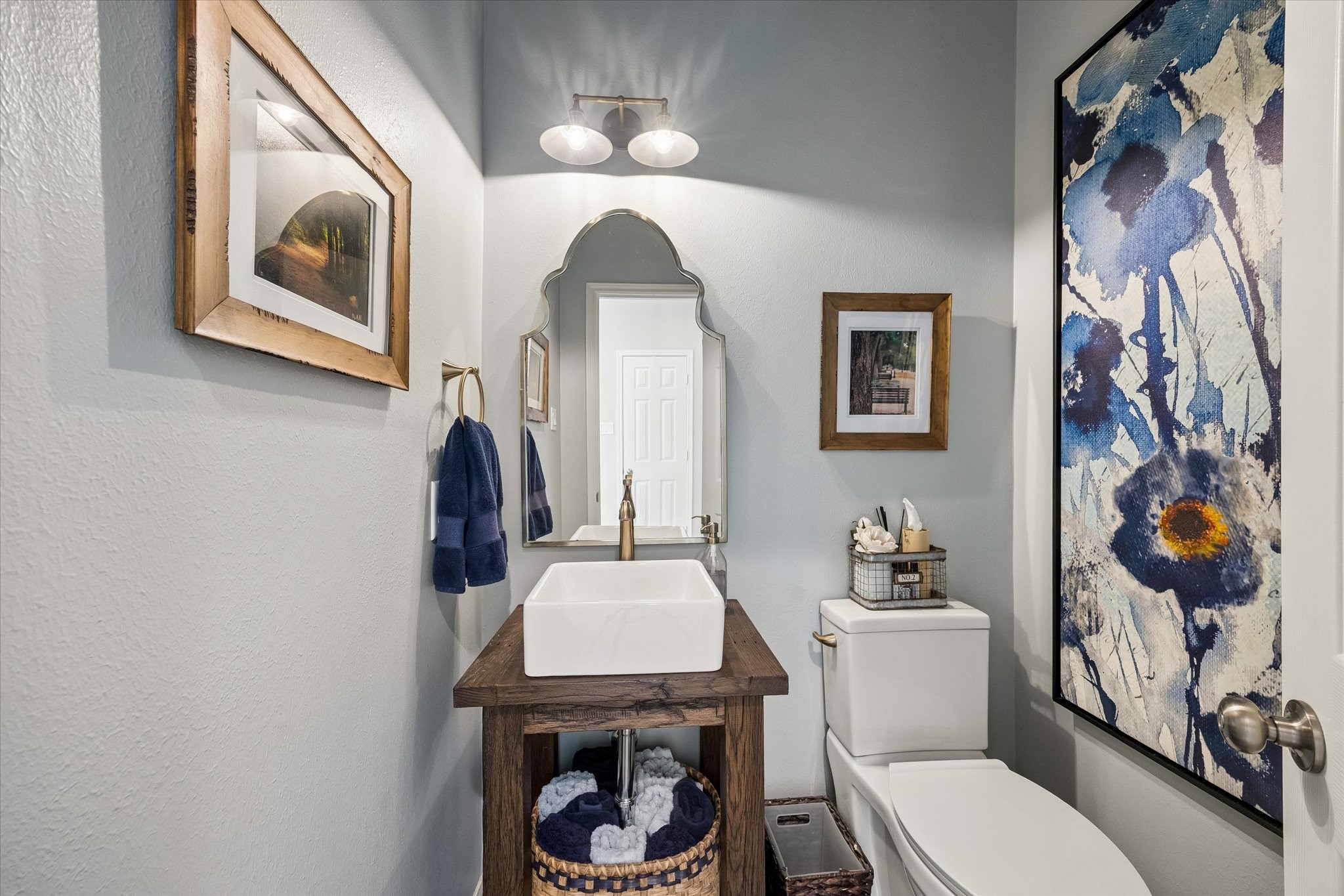 A little personality makes all the difference! This beautifully appointed powder room features distinctive finishes and thoughtful details, creating an inviting space for guests while reflecting the custom touches found throughout the home.