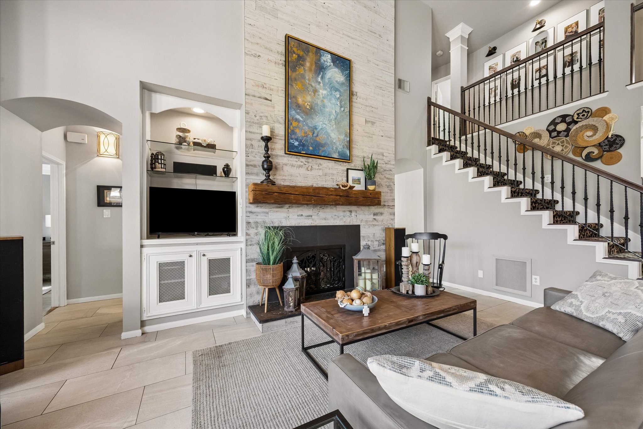 Imagine evenings gathered around the fireplace, sharing stories or settling in for a favorite movie. Soaring ceilings, generous seating space, and a beautiful fireplace with a reclaimed wood mantel create a warm and inviting place to unwind.