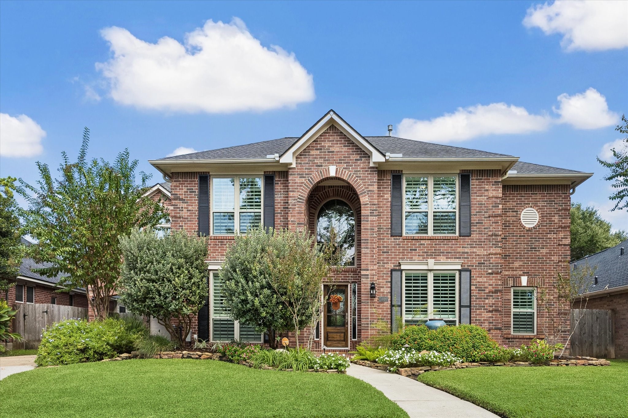 Beautiful brick architecture, mature landscaping, and a welcoming front entrance offers the kind of curb appeal that feels inviting from the moment you arrive.