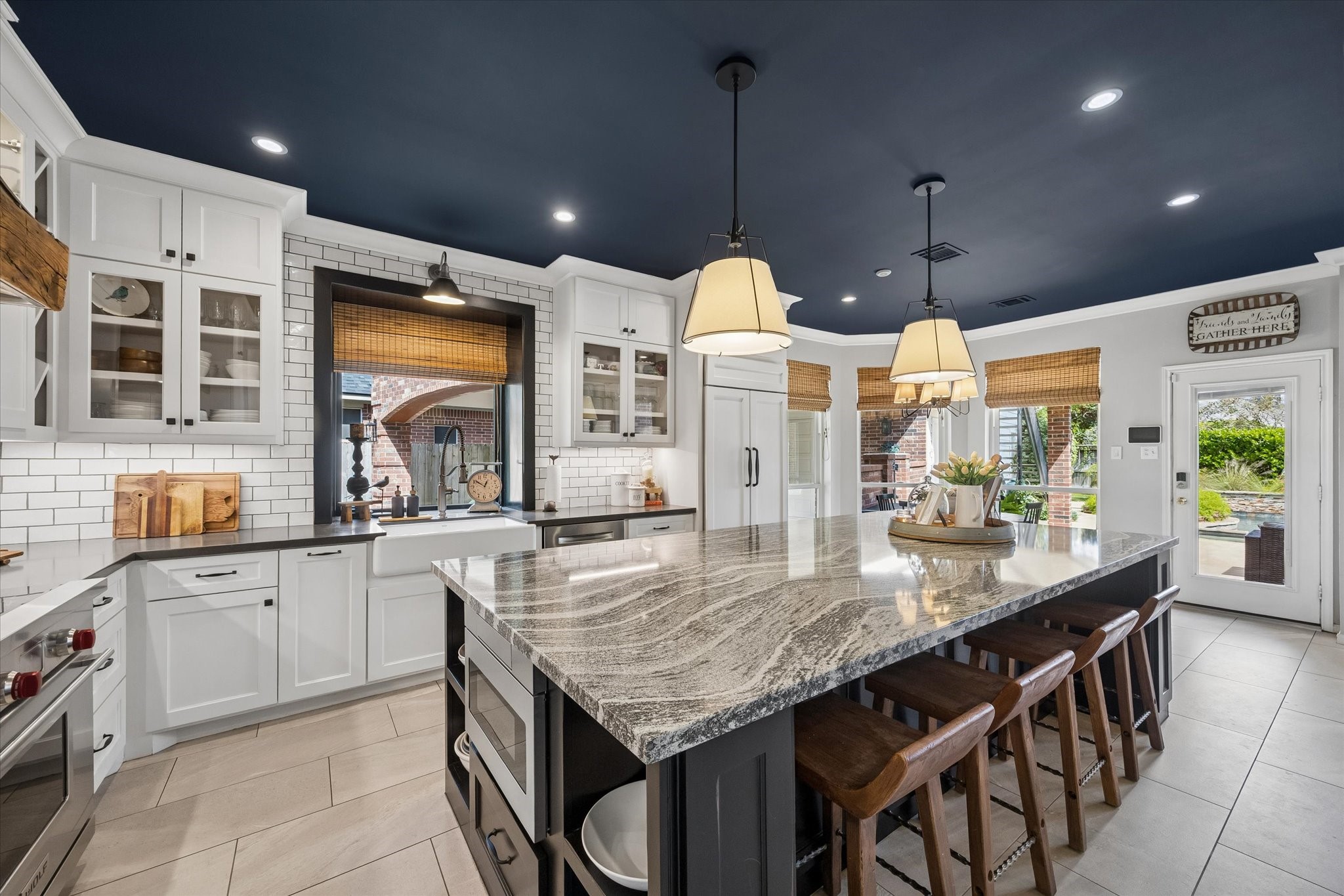 A kitchen designed for serious cooking and memorable gatherings! The professional Wolf range and oven, quartz countertops, custom tile backsplash, and expansive island provide an exceptional combination of performance, beauty, and function.