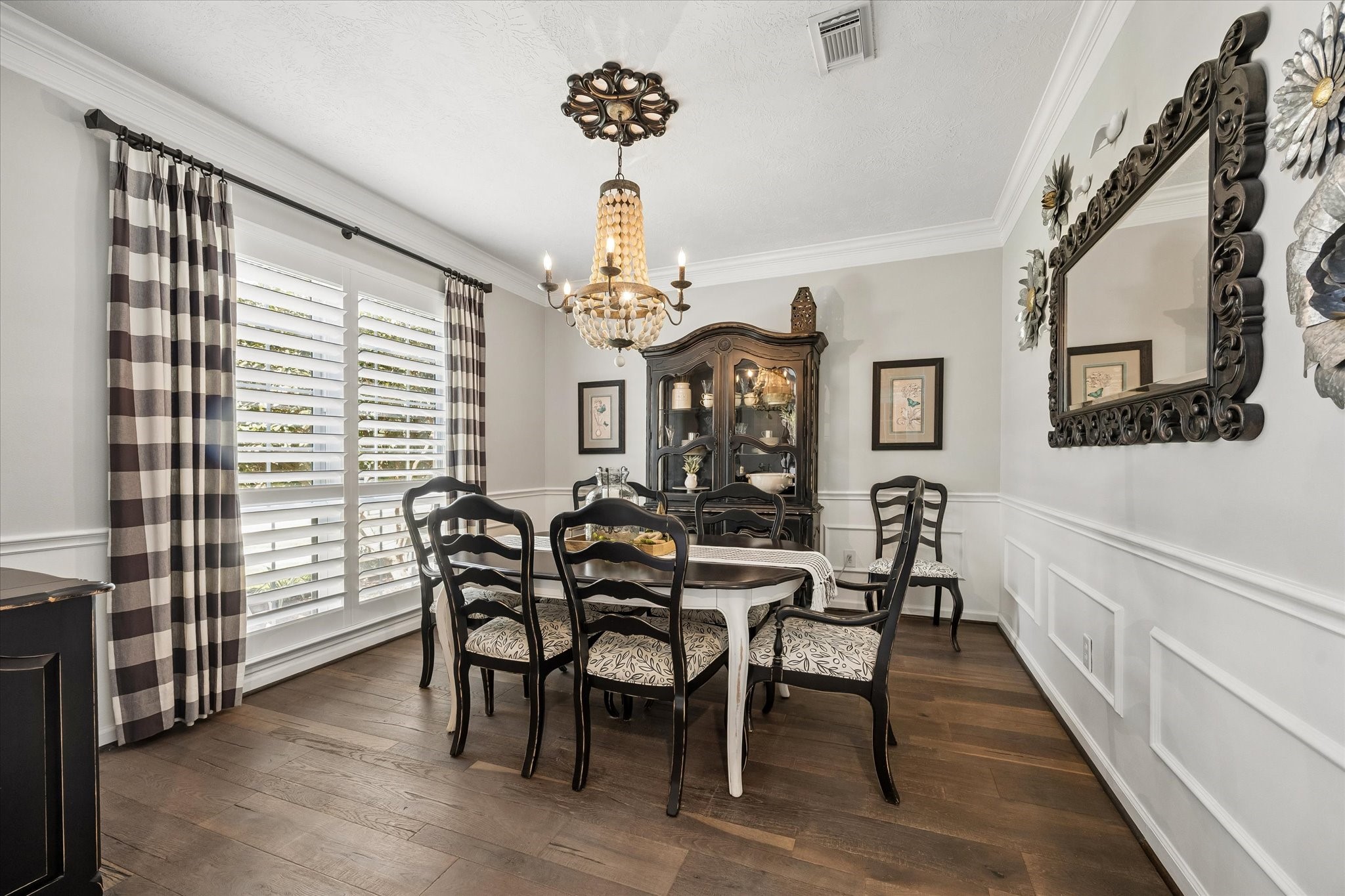 From holiday celebrations to intimate dinners with friends, this elegant dining room provides a beautiful setting for gathering around the table. Rich wood flooring, decorative molding, and natural light add warmth and character to every occasion.