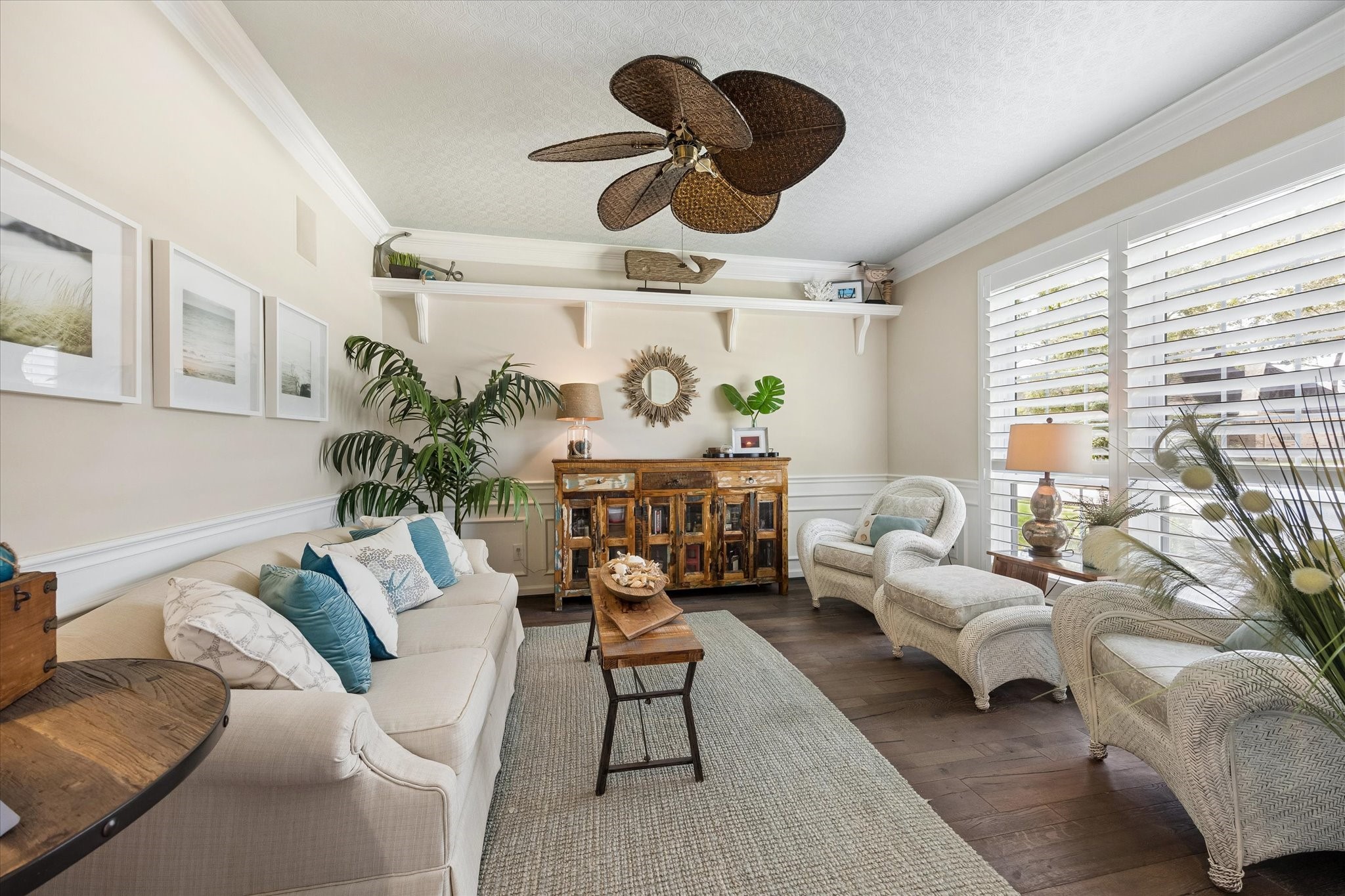 A quiet retreat away from the main gathering spaces, this inviting living room offers the perfect setting for morning coffee, afternoon reading, or catching up with friends. Rich wood flooring, plantation shutters, and beautiful French doors add warmth and timeless character.