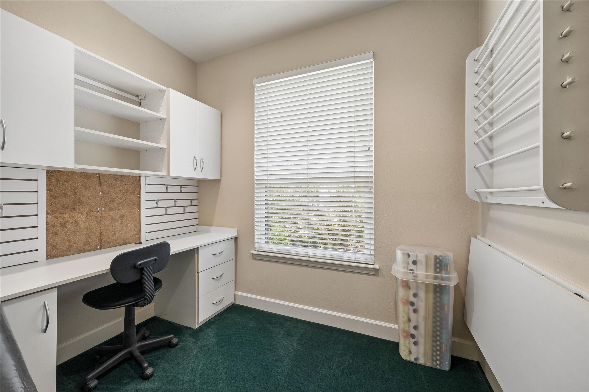 Whether you're working through your to-do list, wrapping gifts, or enjoying a favorite hobby, this dedicated workspace keeps everything within reach. Built-in cabinetry, shelving, and a spacious desk make staying organized effortless.