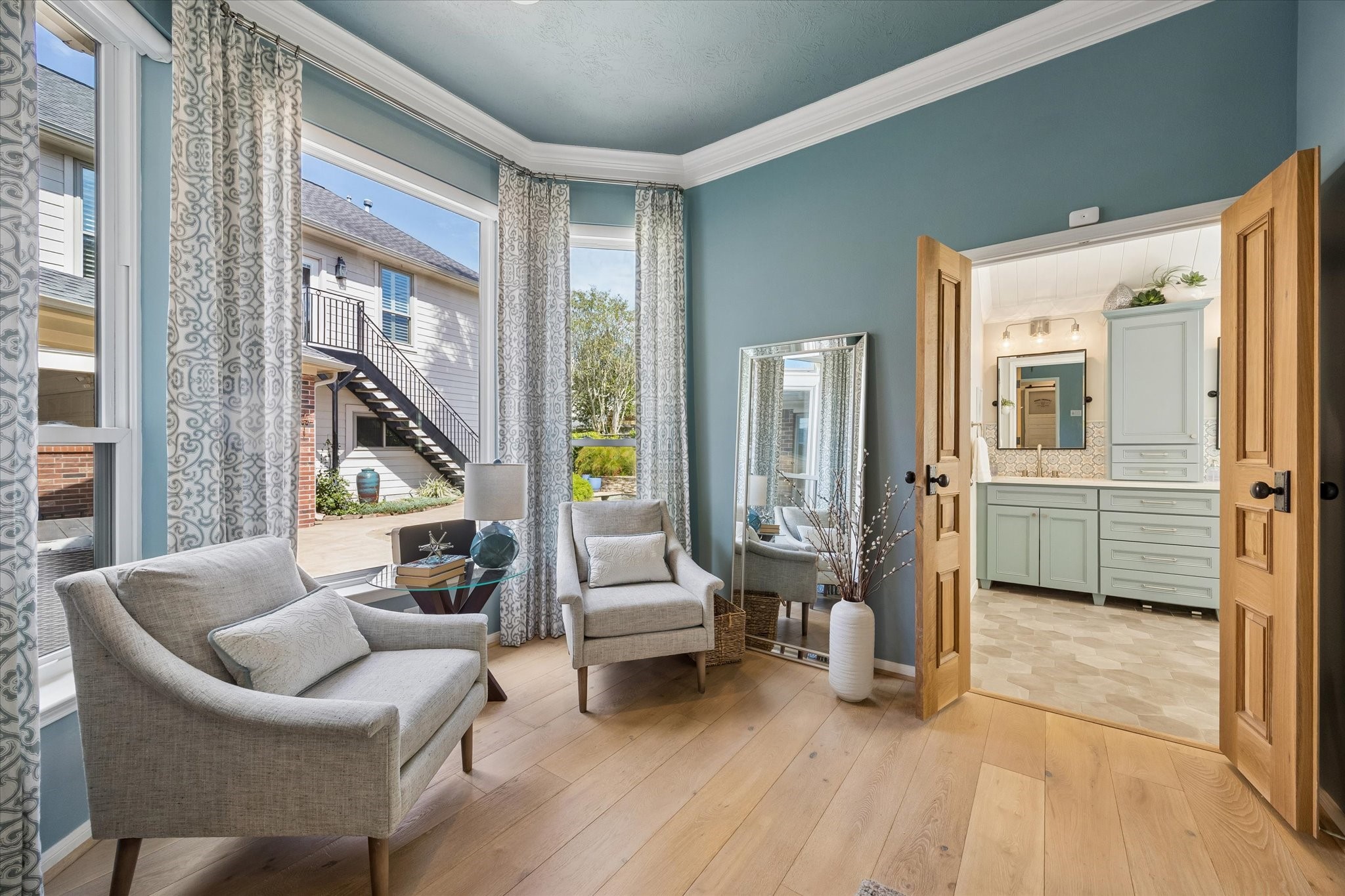 A peaceful corner to call your own! Whether enjoying morning coffee, curling up with a favorite book, or simply taking a moment to relax, the primary suite's sitting area offers a welcome retreat from the day's activities.