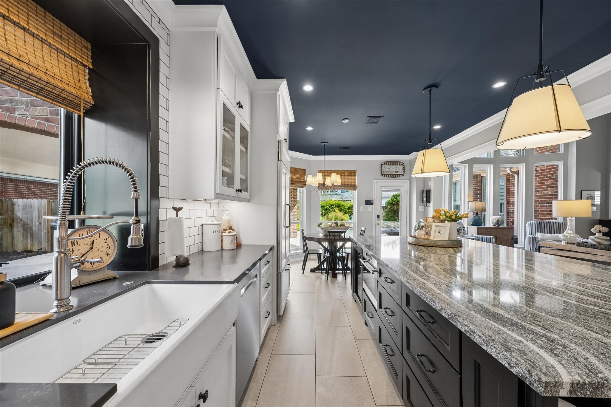 A charming farmhouse sink, thoughtfully designed cabinetry and generous counter space create an inviting workspace that combines style, function, and convenience.