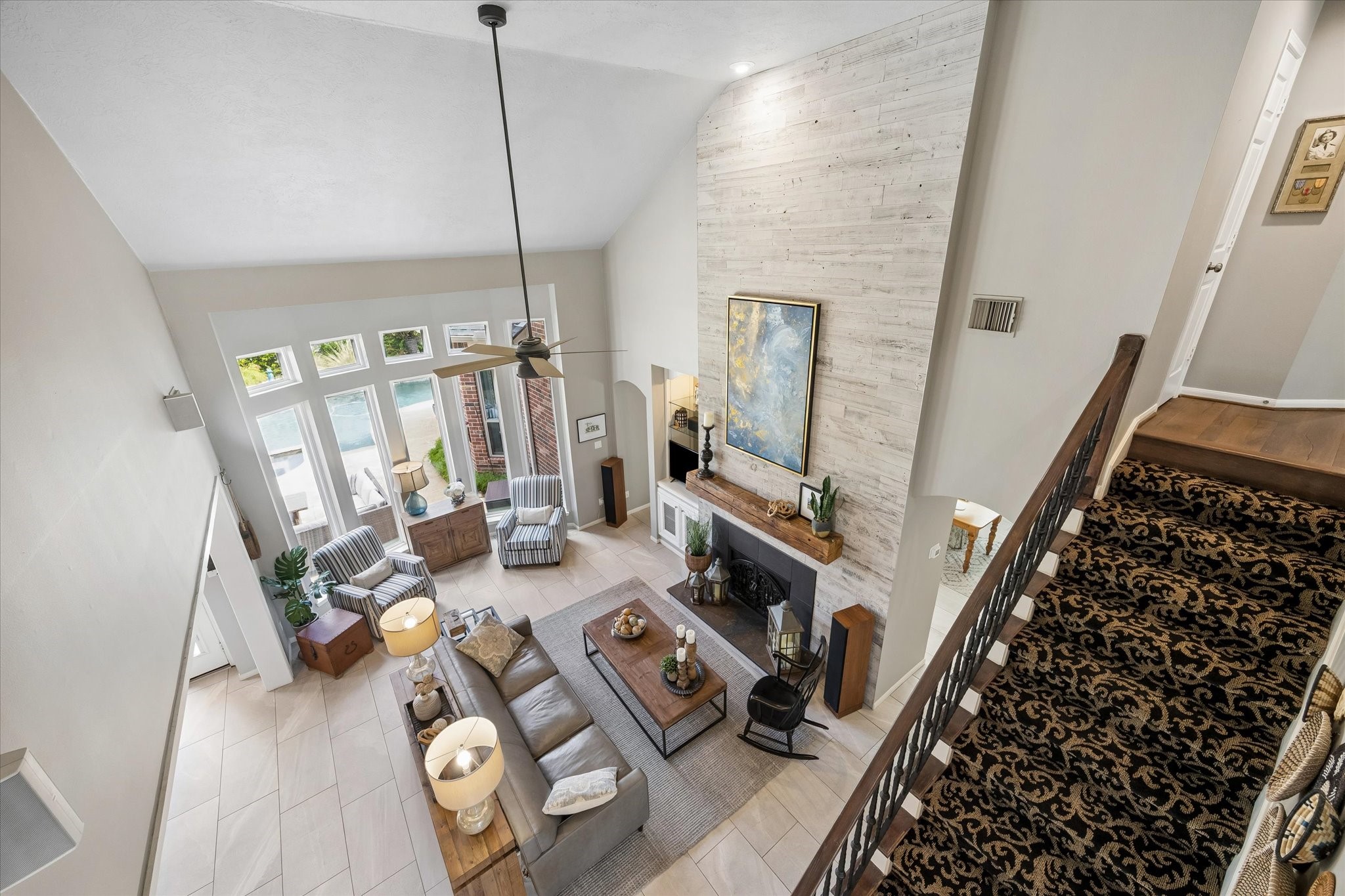 Looking down from the upstairs landing, the impressive ceiling heights and open architectural design become even more apparent. This beautiful perspective highlights the home's spacious feel and connection between the living areas.