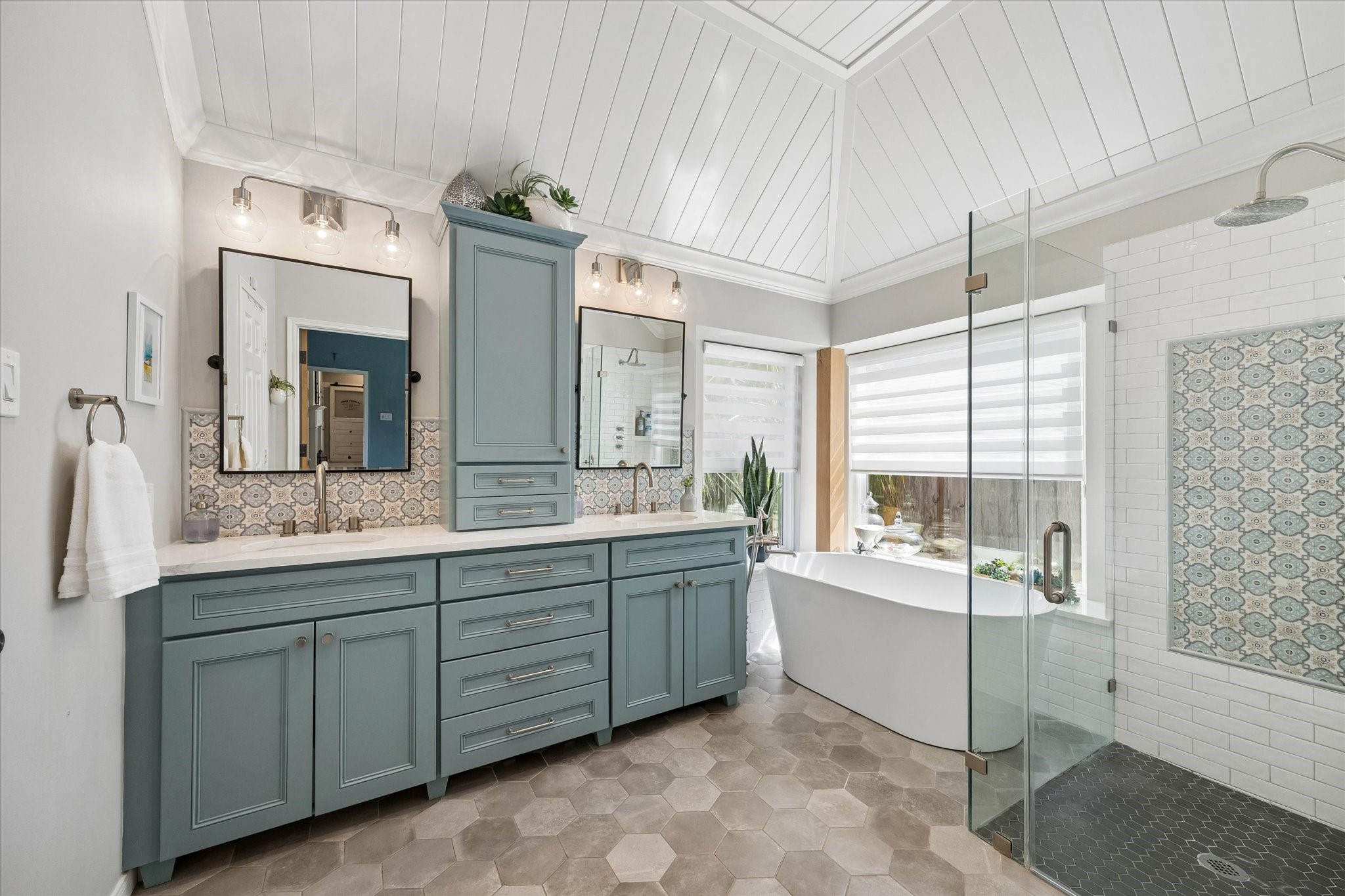 Bring a little spa-inspired luxury into your everyday routine! Beautifully remodeled with a freestanding soaking tub, spacious shower, updated vanities, and custom tile finishes, this primary bathroom is designed to make every day feel a little more relaxing.