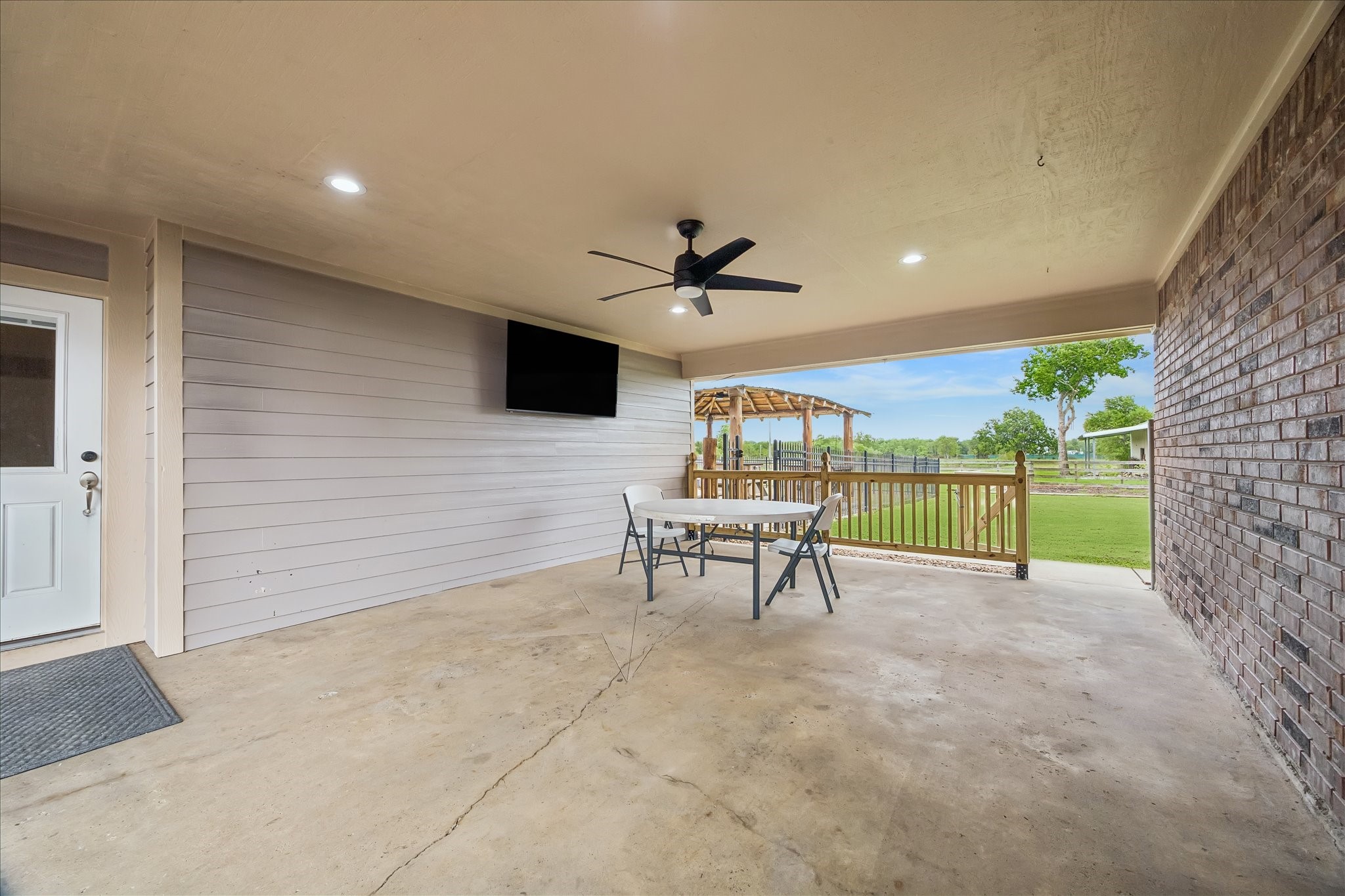 Breezeway with TV adjoins the house and garage.