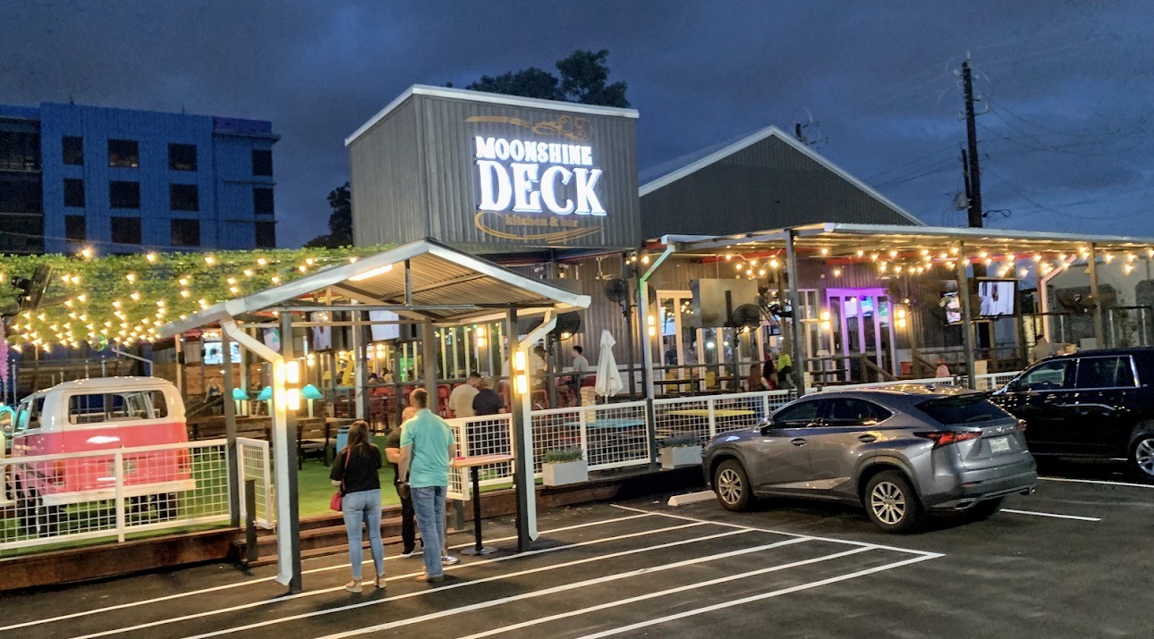 Moonshine Deck, located just a short walk away, offers an inviting outdoor patio, casual dining, and a lively atmosphere for enjoying the Greater Heights nightlife.