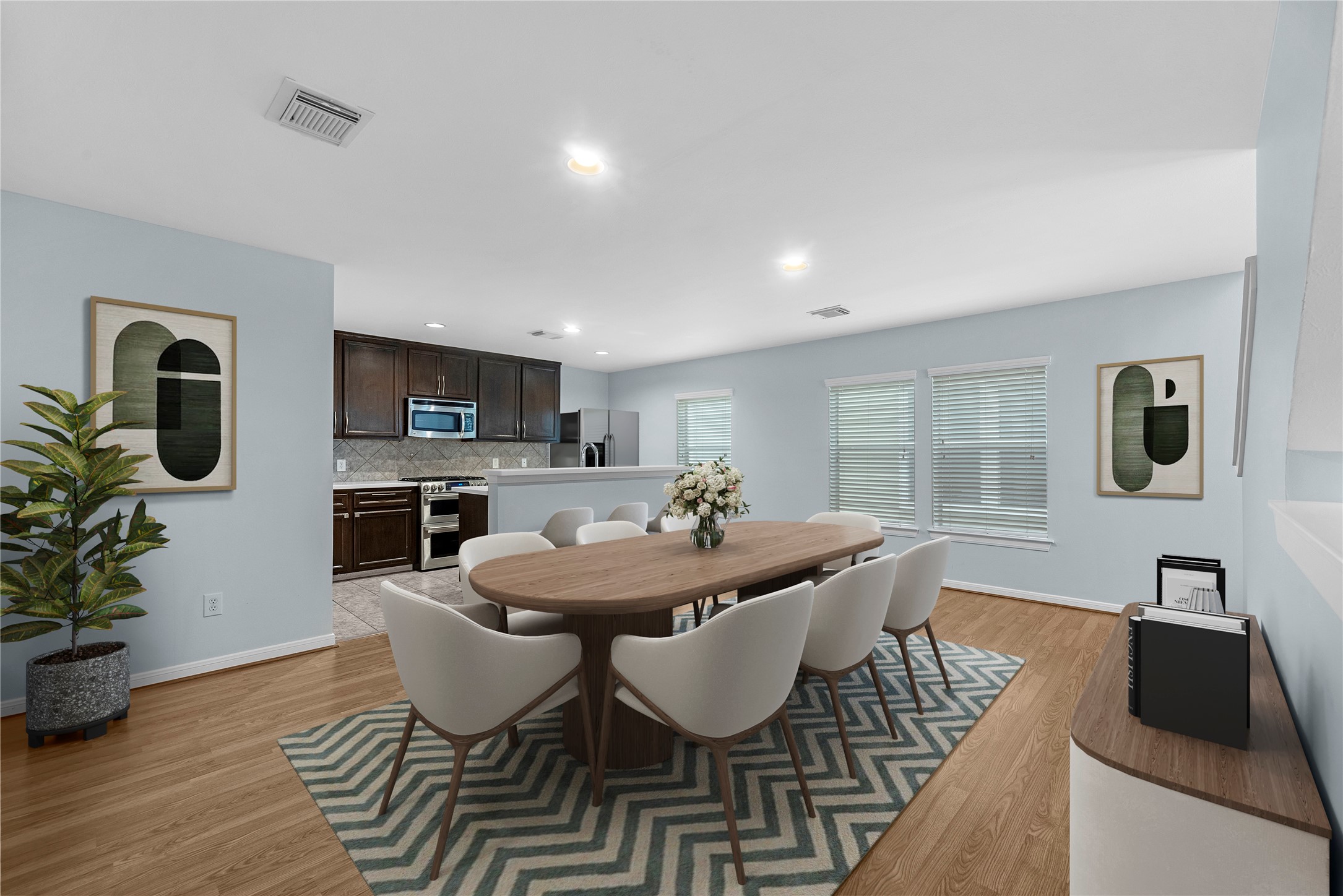 This virtually staged kitchen and dining area showcases rich brown cabinetry, granite countertops, a tile backsplash, and stainless steel appliances. The spacious layout offers plenty of room for everyday dining and entertaining.