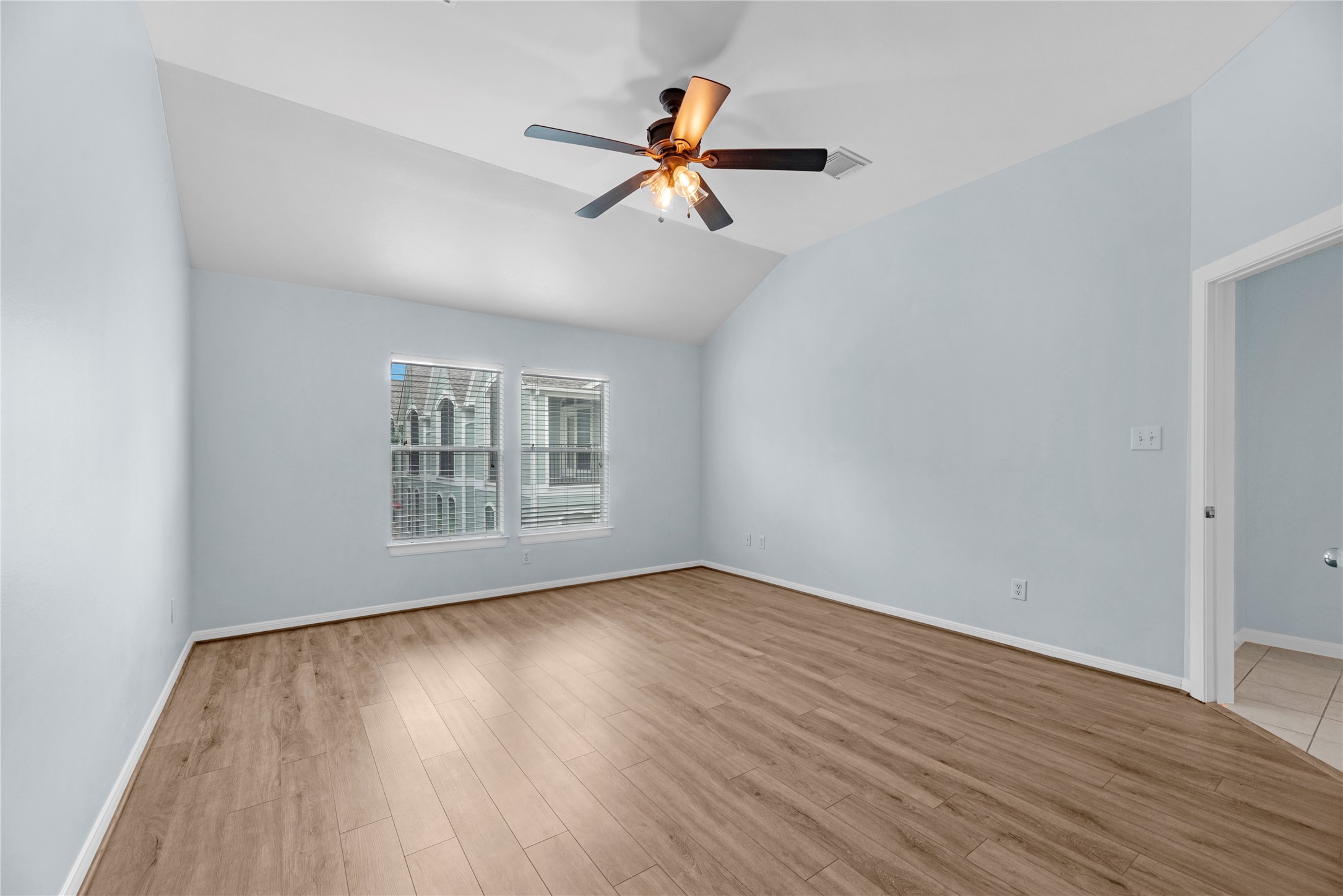 This spacious bedroom offers an open layout with plenty of room to create a comfortable sleeping area while still allowing space for additional furniture, a sitting area, or workspace.