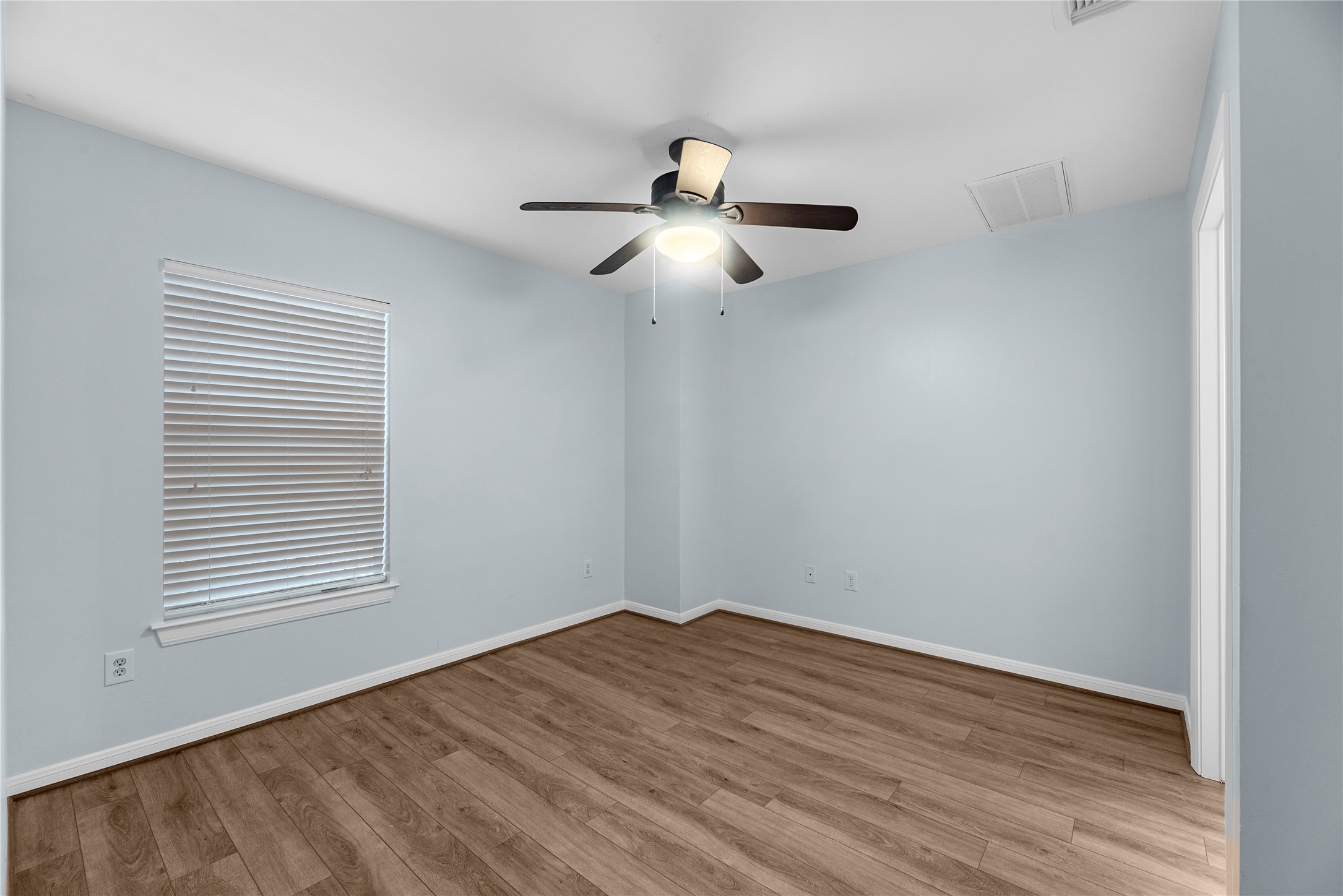 Located on the first floor just off the entry, this private guest suite offers a comfortable and versatile space with updated flooring, natural light, and its own en suite bathroom for added convenience and privacy
