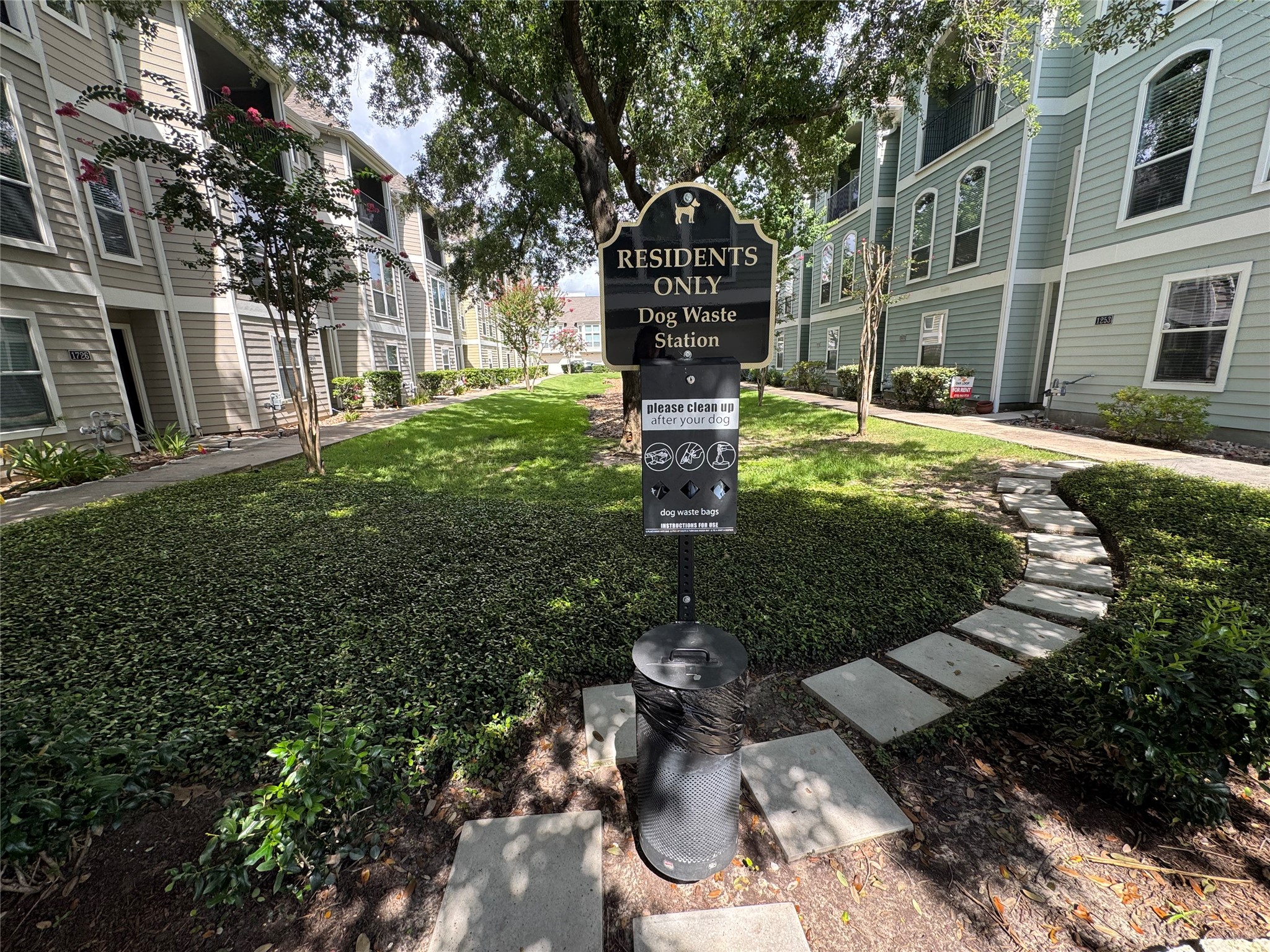 The community features a beautifully maintained green space with mature trees, landscaped walkways, and a convenient dog waste station for resident; which is included in your HOA.
