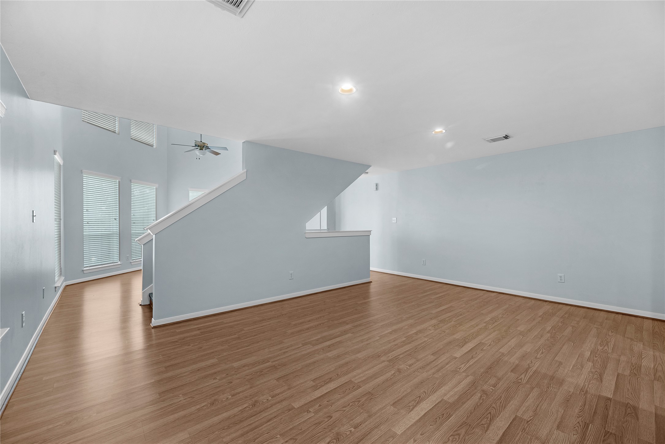 View from the staircase overlooking the kitchen and dining area, showcasing the open second-level layout and connection between the homes main living spaces.