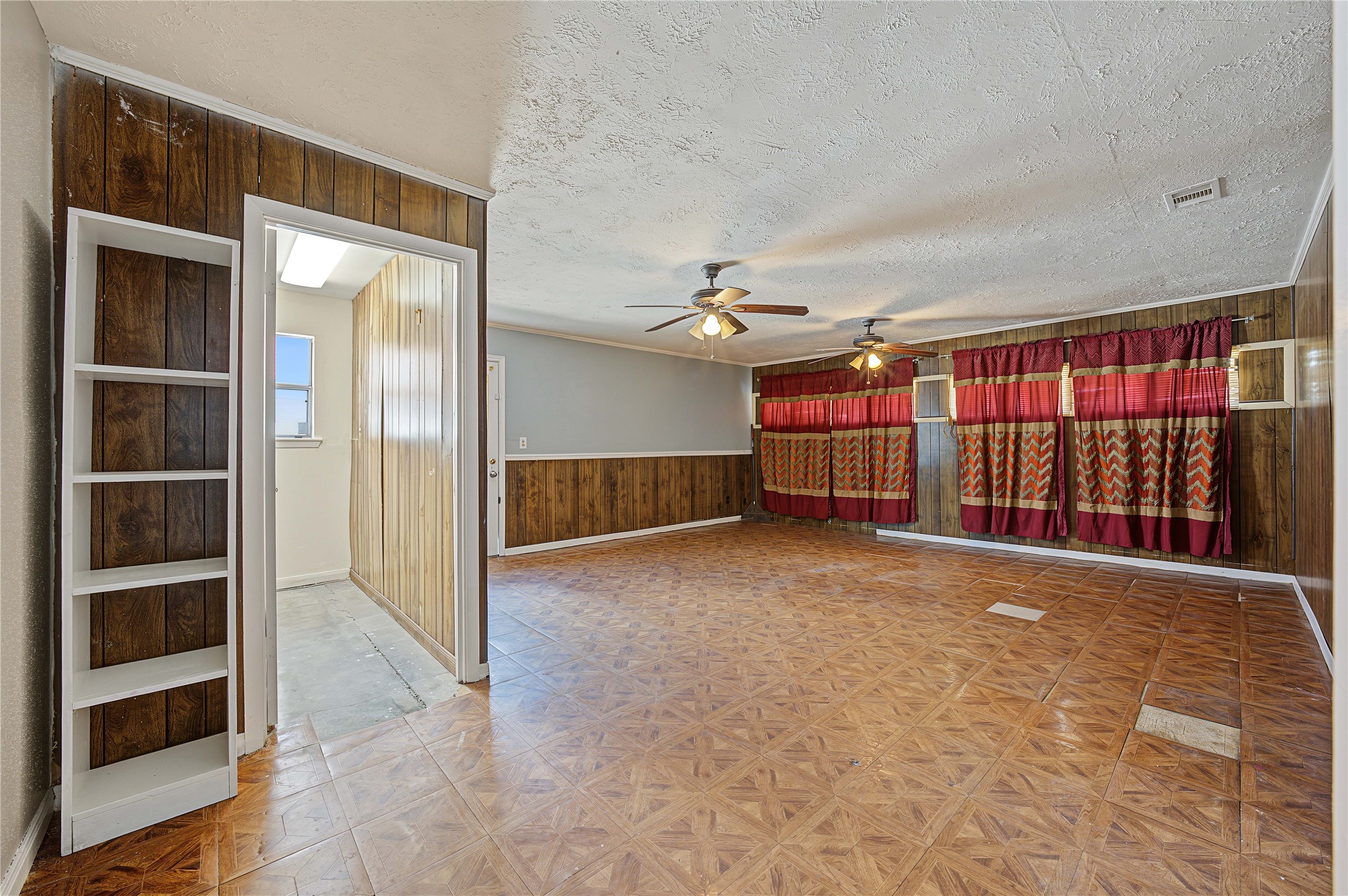 Large den or secondary living space showcasing freshly painted walls and great character.