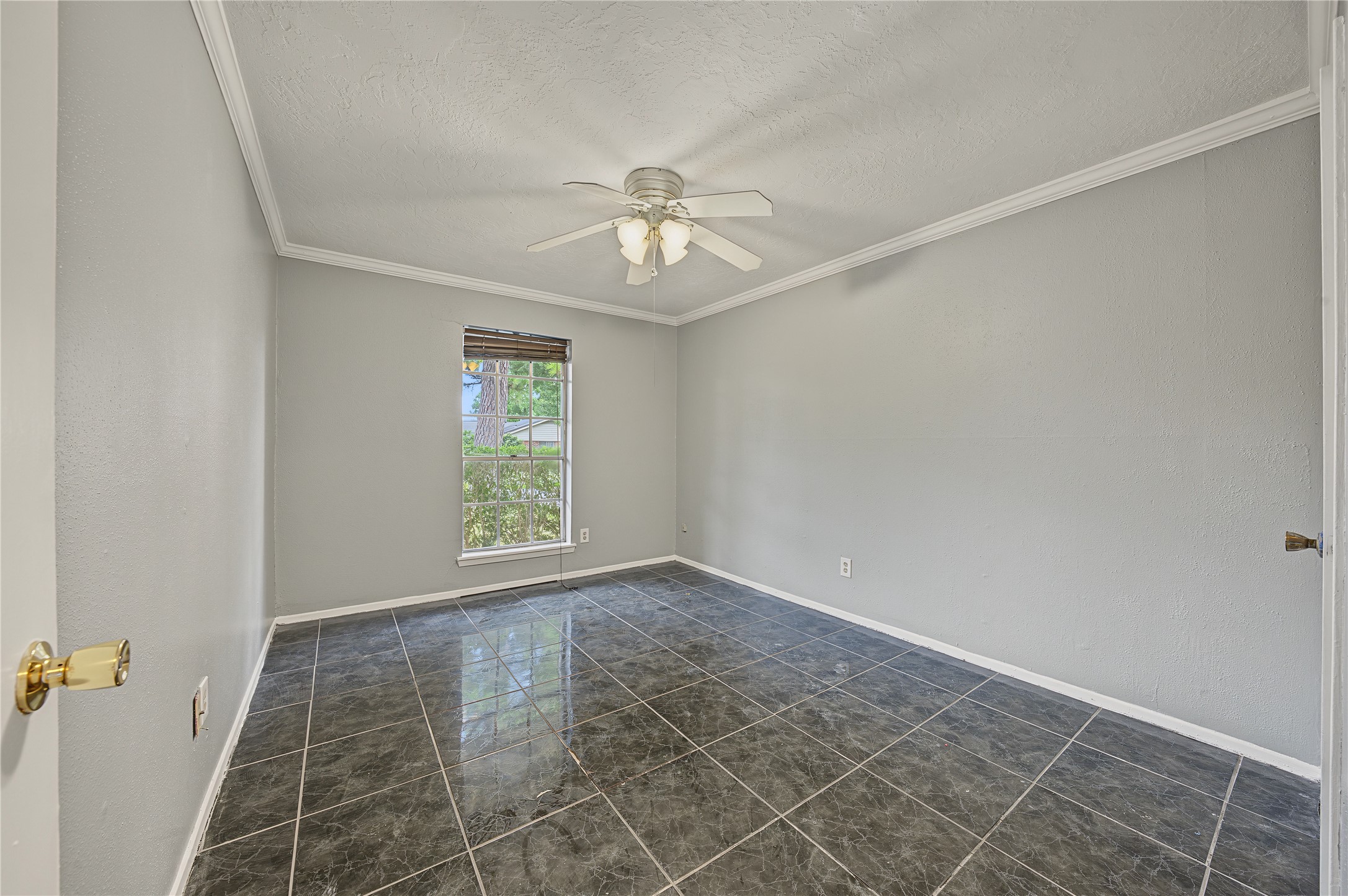 Additional bedroom featuring fresh interior paint and tile flooring.