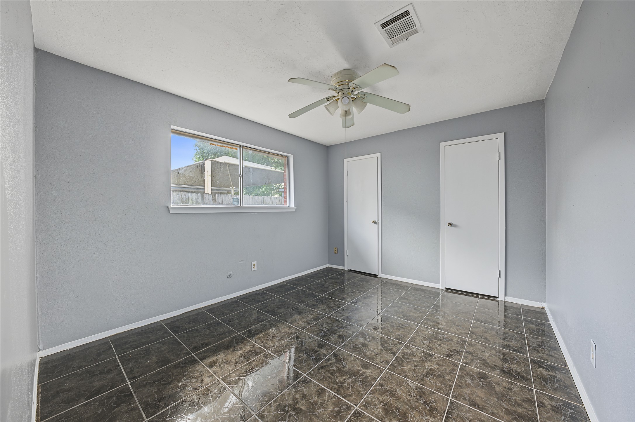 Secondary room with freshly painted walls, ready for your customization.