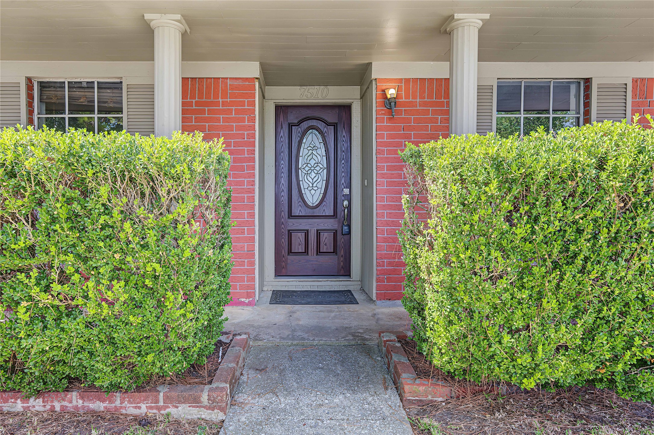 Inviting front entryway featuring a charming brick facade and fresh curb appeal.