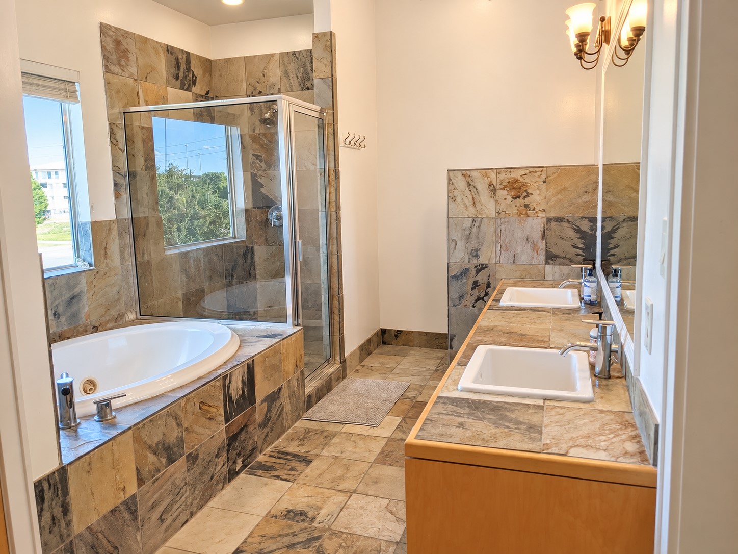Comfortable primary retreat featuring a soaking tub and detached shower.