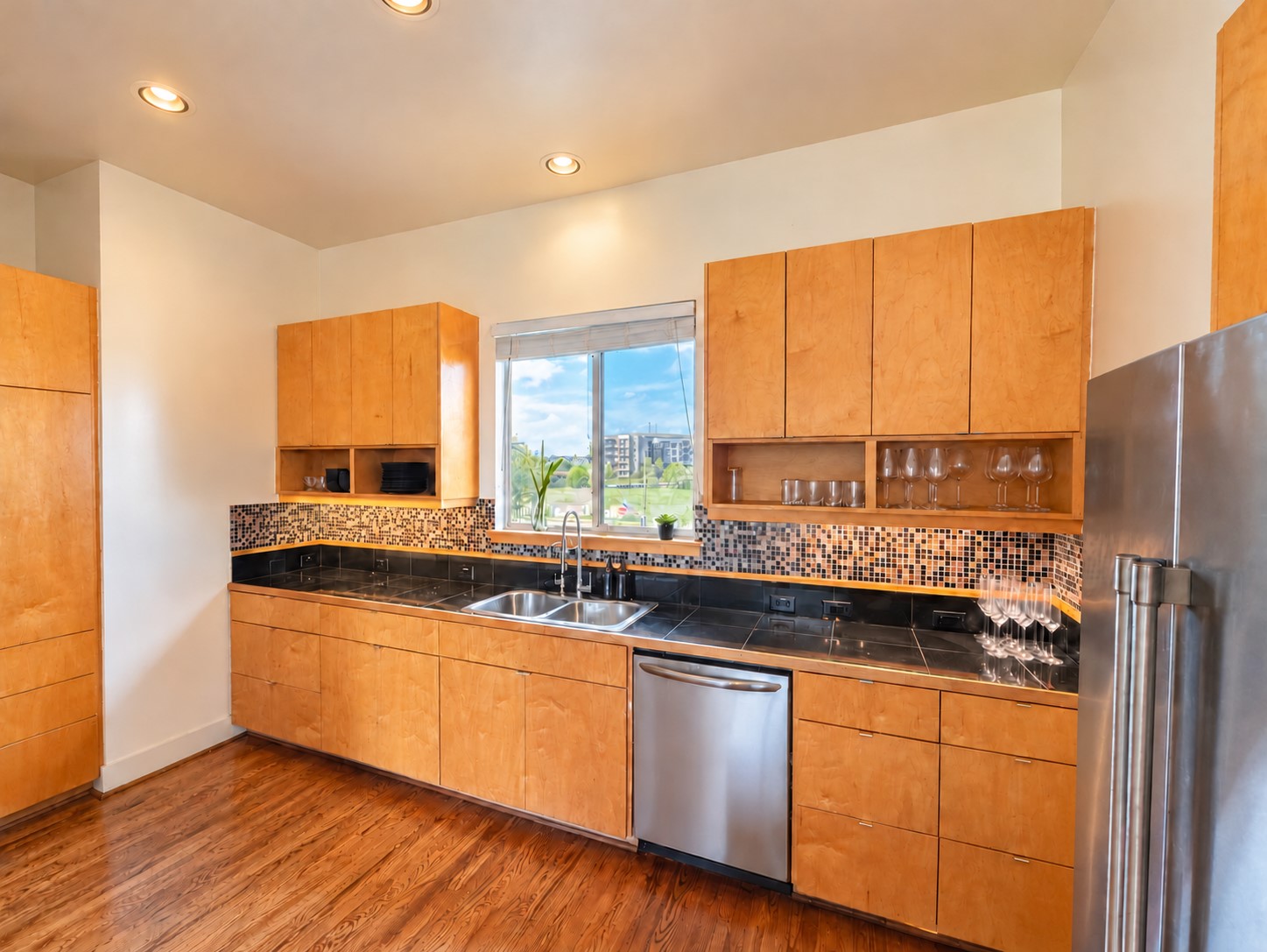 Fully equipped kitchen stocked with cookware, dinnerware, and essentials for a seamless move-in experience.