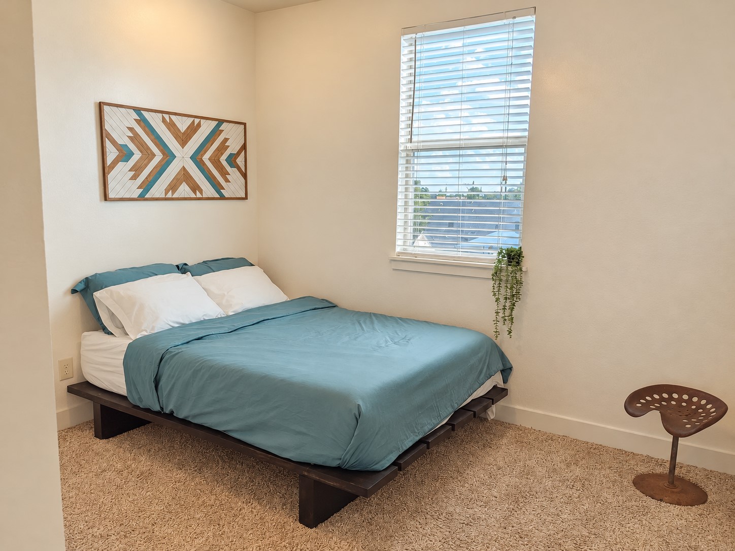 Well-appointed upstairs bedroom with inviting furnishings and comfortable bedding. Ensuite bathroom has a free standing shower.