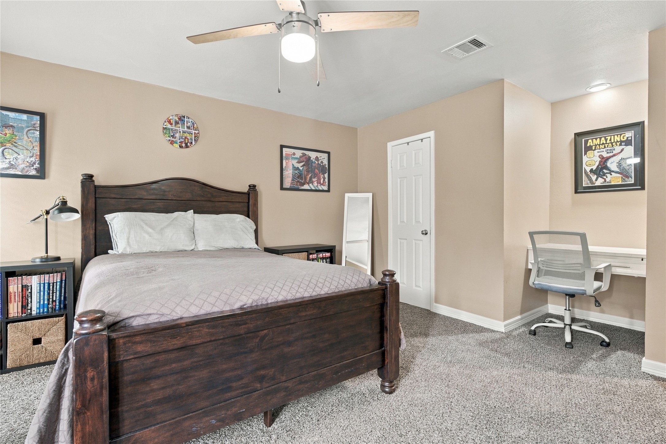 A built-in desk alcove w/ its own recessed light sits beside the closet, ideal for homework or remote work.
