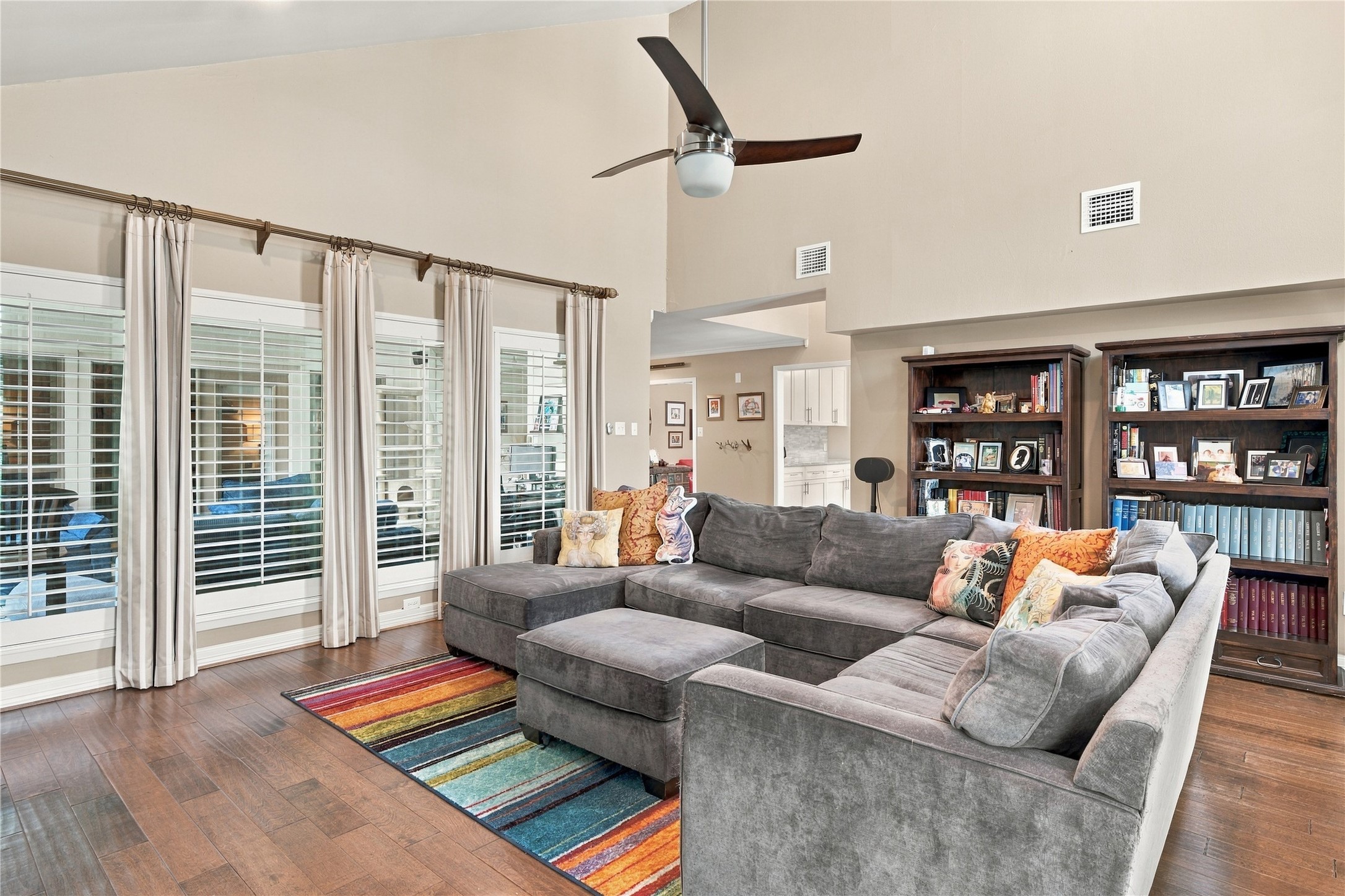 A full wall of shuttered windows looks directly into the sunroom, borrowing its light & adding depth to the living room.