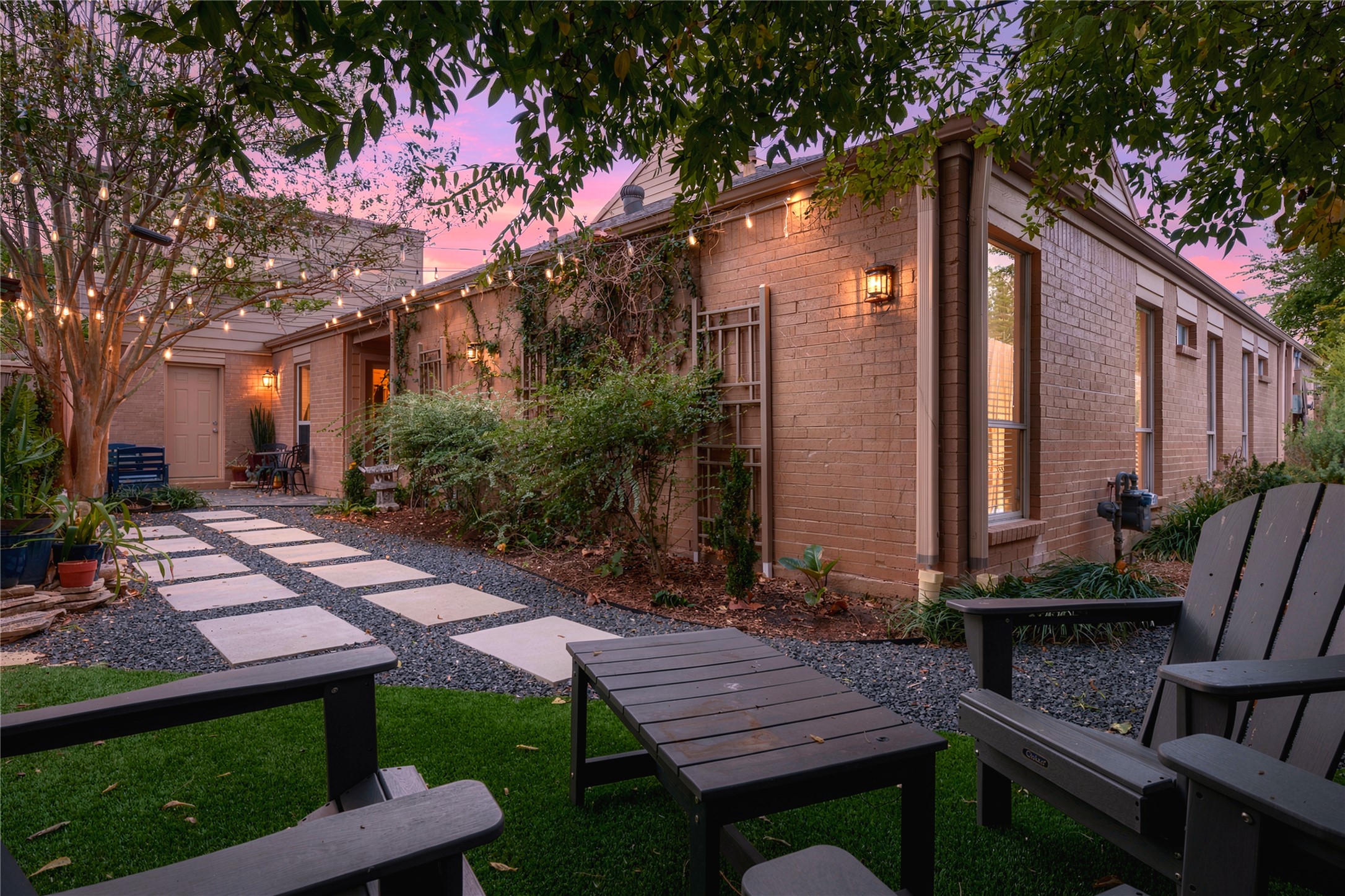 The courtyard truly comes alive at dusk! Thoughtful lighting, glowing wall sconces & climbing vines on the brick create a wonderful setting for evenings outside.
