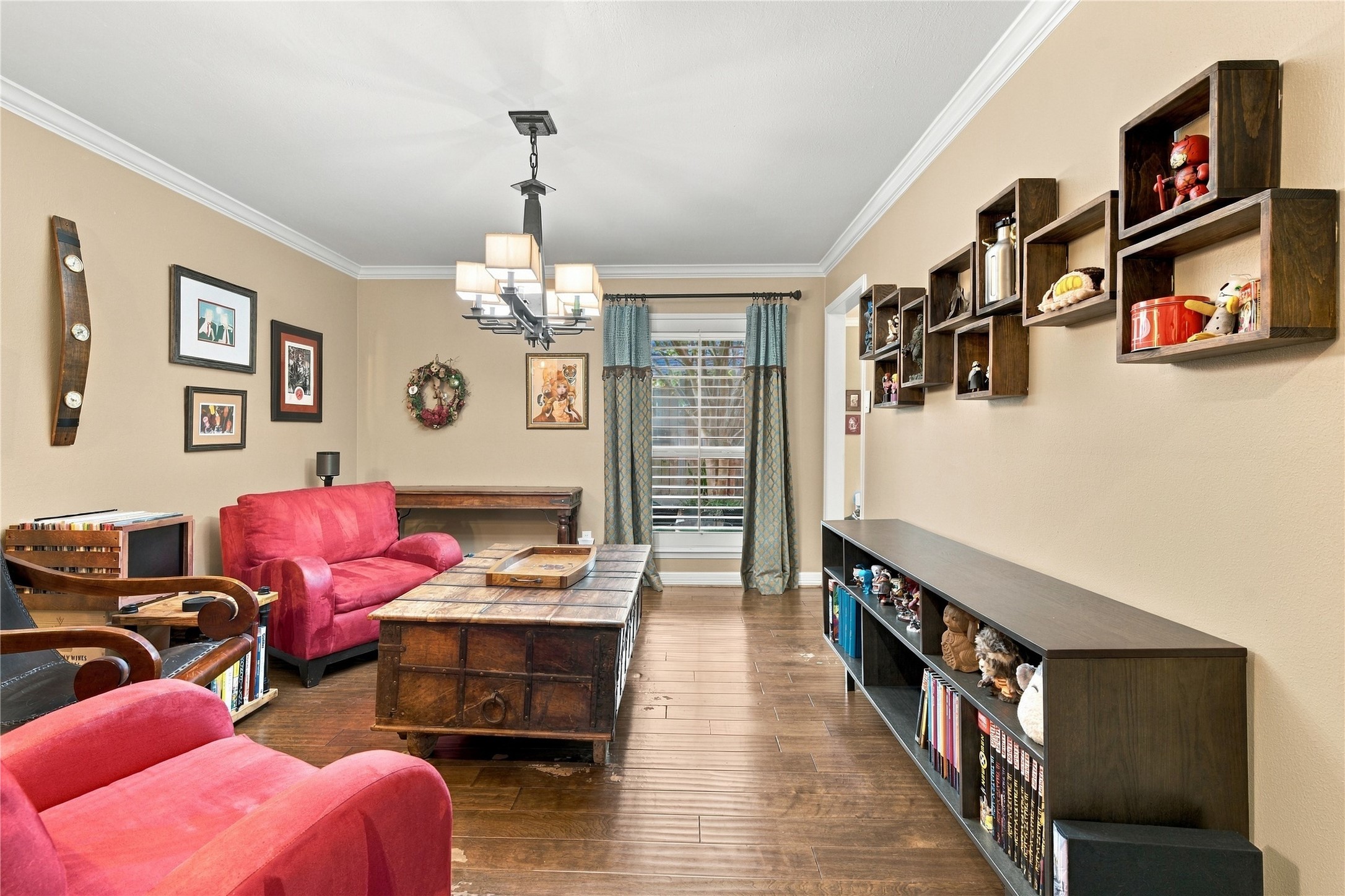 The room's long proportions offer flexibility for formal dining, a den, or a home library, with a plantation-shuttered window bringing in soft natural light.