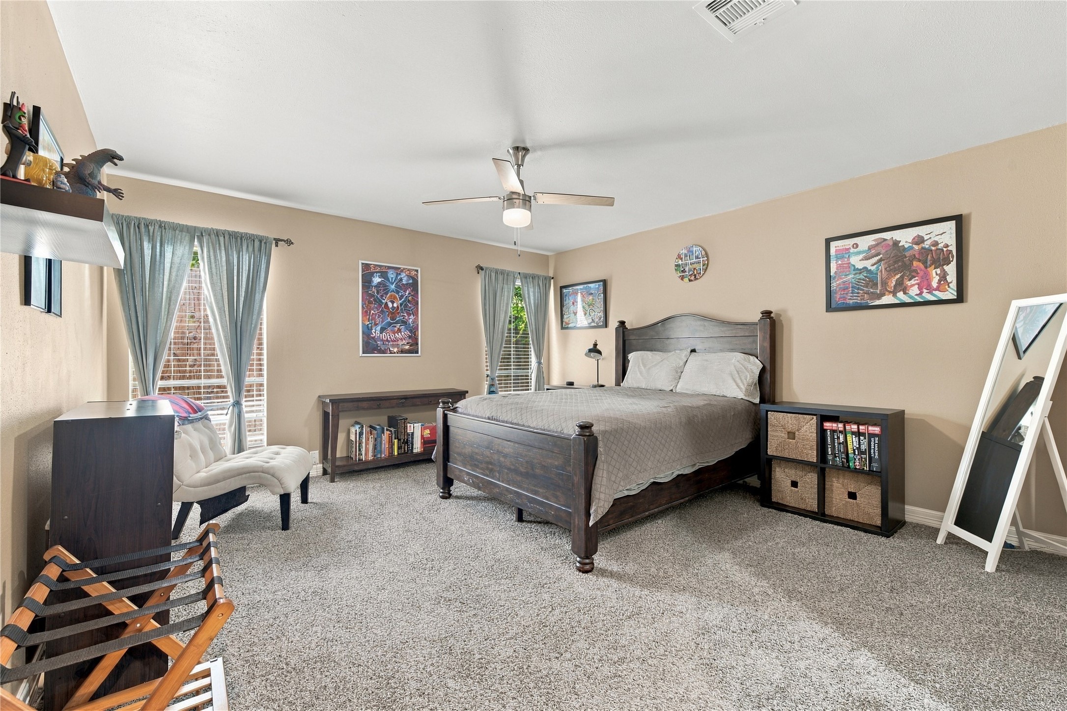 This spacious secondary bedroom offers generous floor space, plush carpet, and 2 large windows that flood the room with natural light.