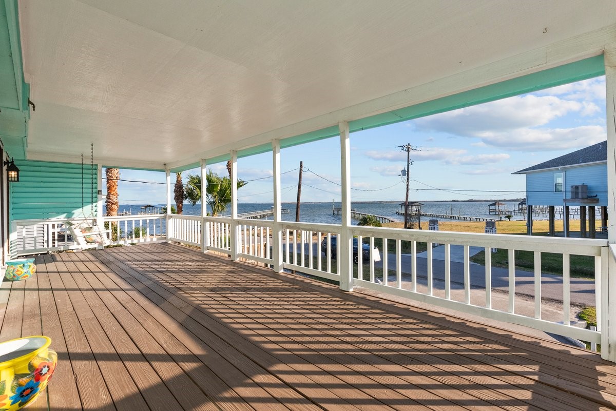 Spacious covered porch with bay views, perfect for relaxing and enjoying the coastal breeze. Spacious covered porch with bay views, perfect for relaxing and enjoying the coastal breeze.