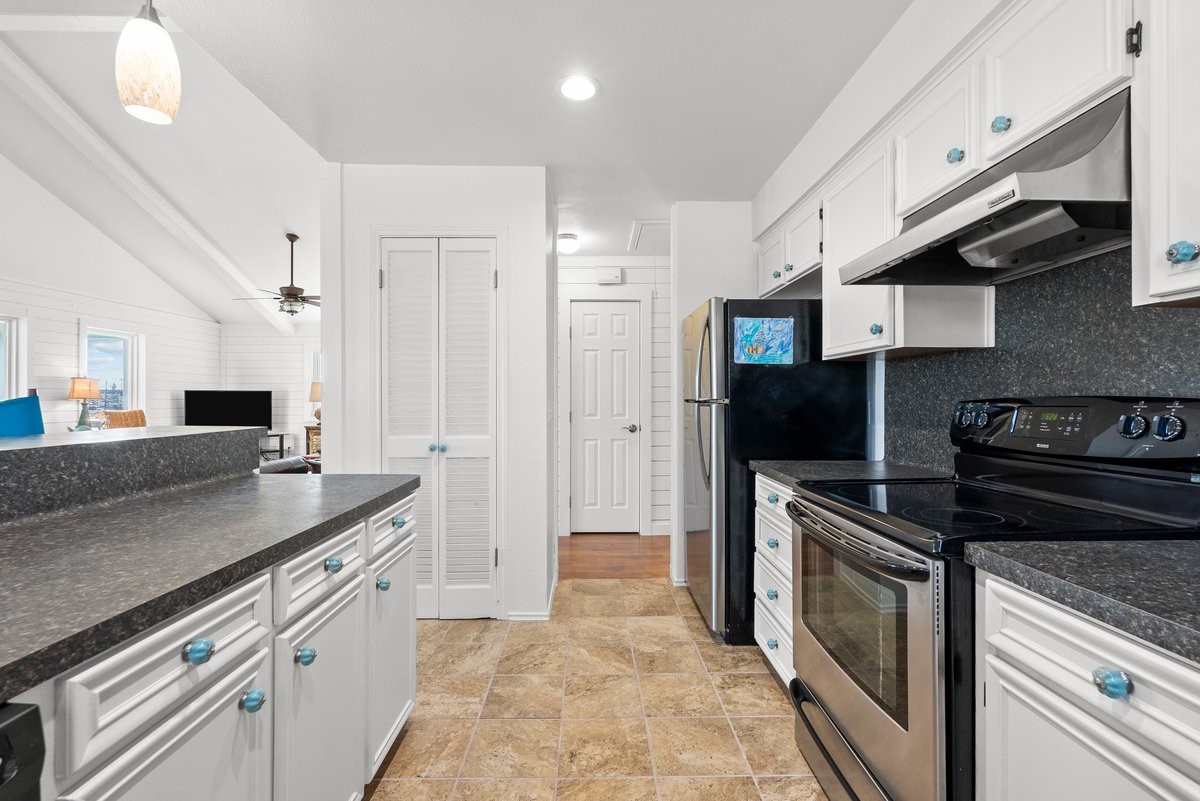 The space features tiled flooring and opens to a living area.