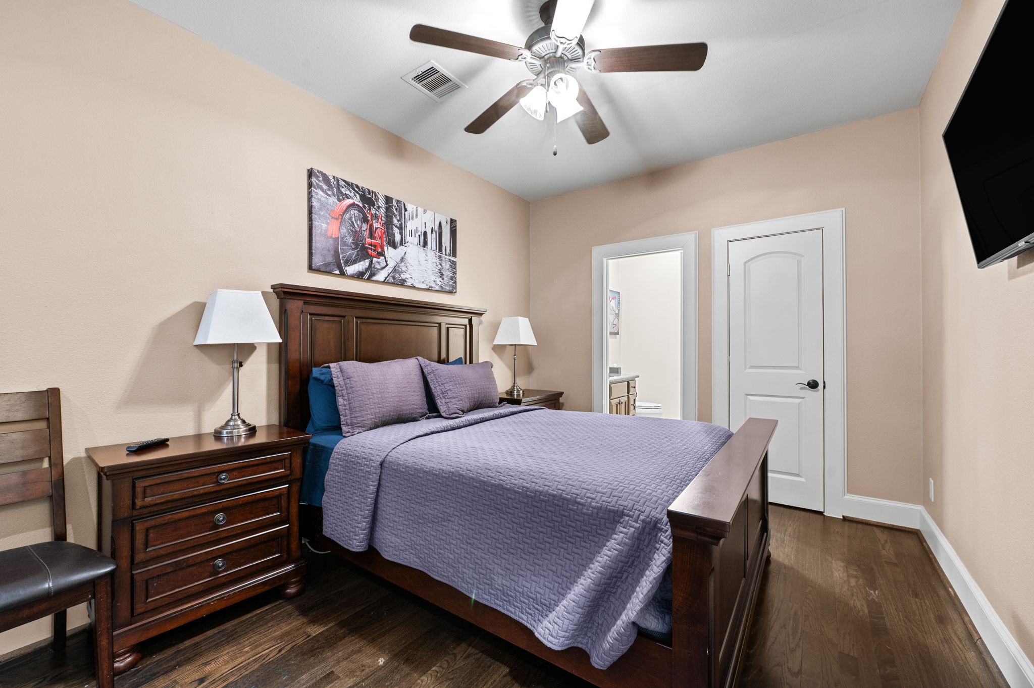 Bedroom 3 is located on the first floor and boasts a walk in closet, ensuite bathroom, and wood floors.
