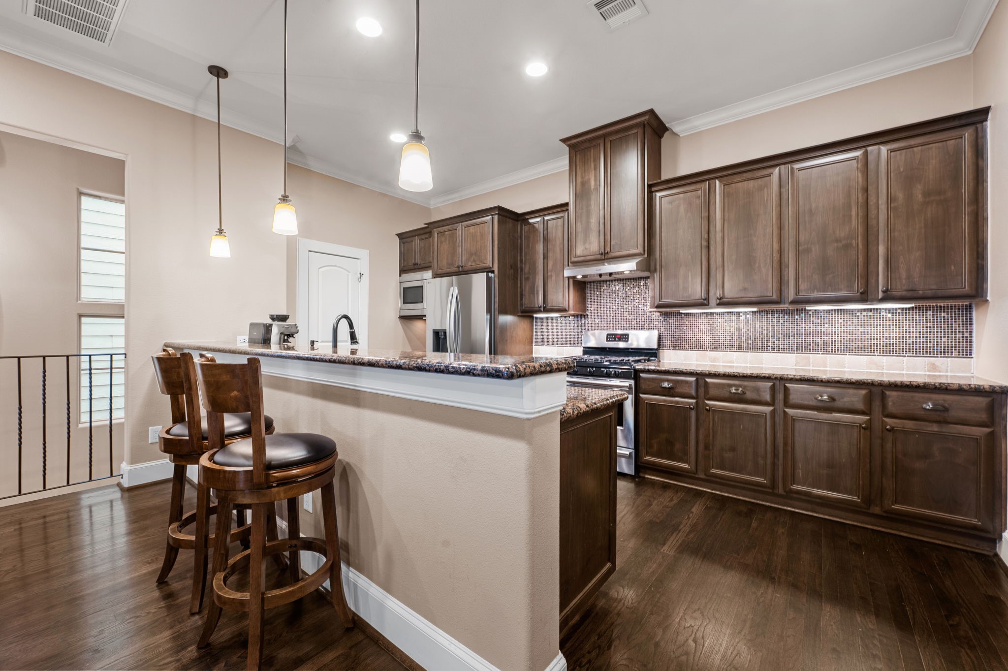 The kitchen opens up to the dining and living room and boasts  an elongated bar height counter top which is great for entertaining.