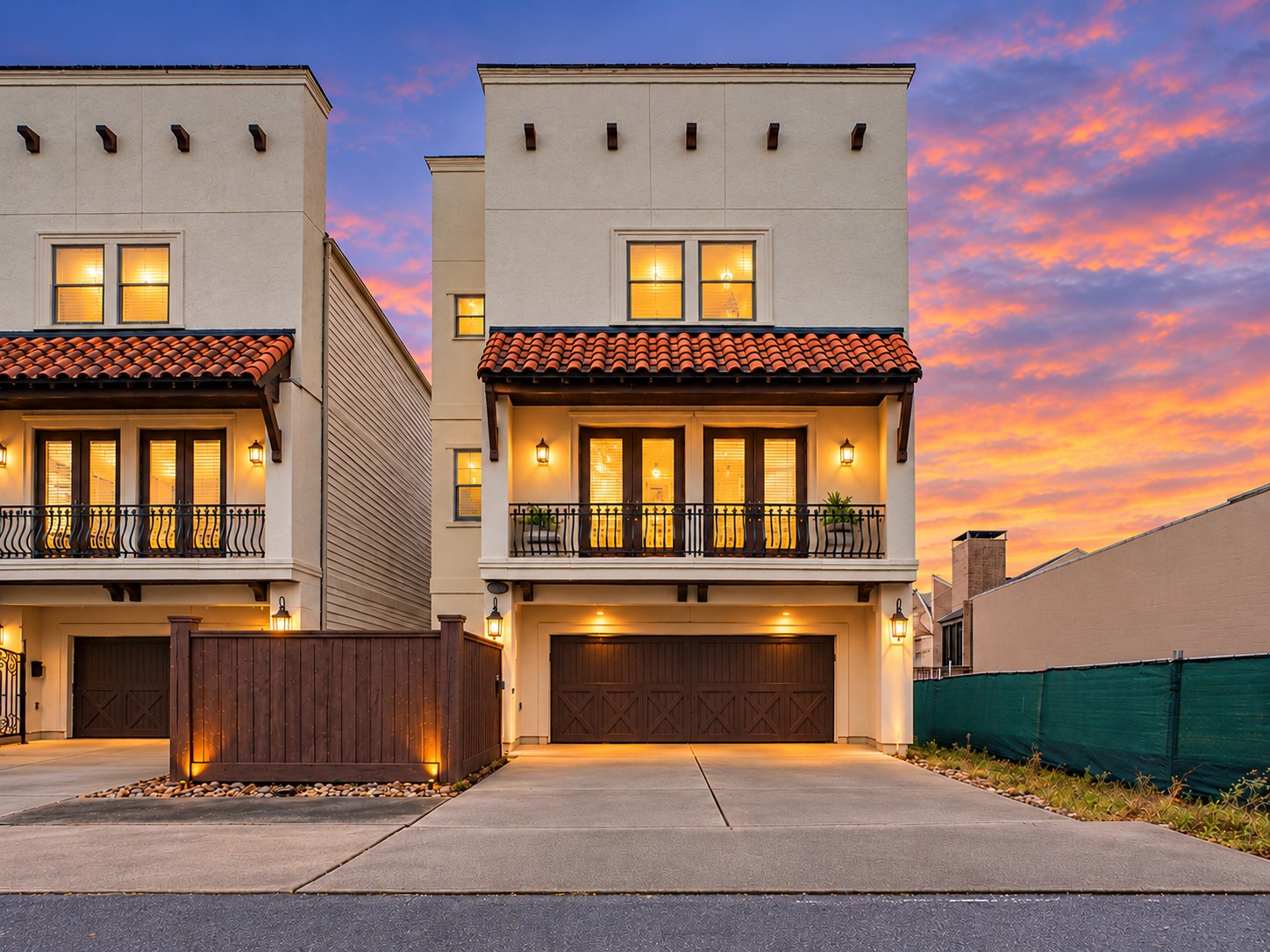 AI enhanced with twighlight background and added lighting in front of the fence and soffit. This Patio Home has amazing curb appeal and it's own private driveway.  There is a gated front entry for privacy and security that leads you and your guests through your front gated courtyard space.