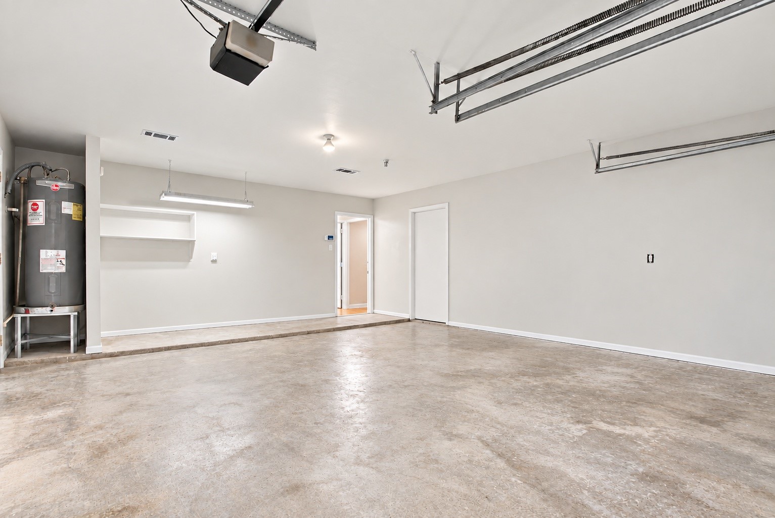 The two car garage with a BRAND NEW water heater and it has tesla charges!