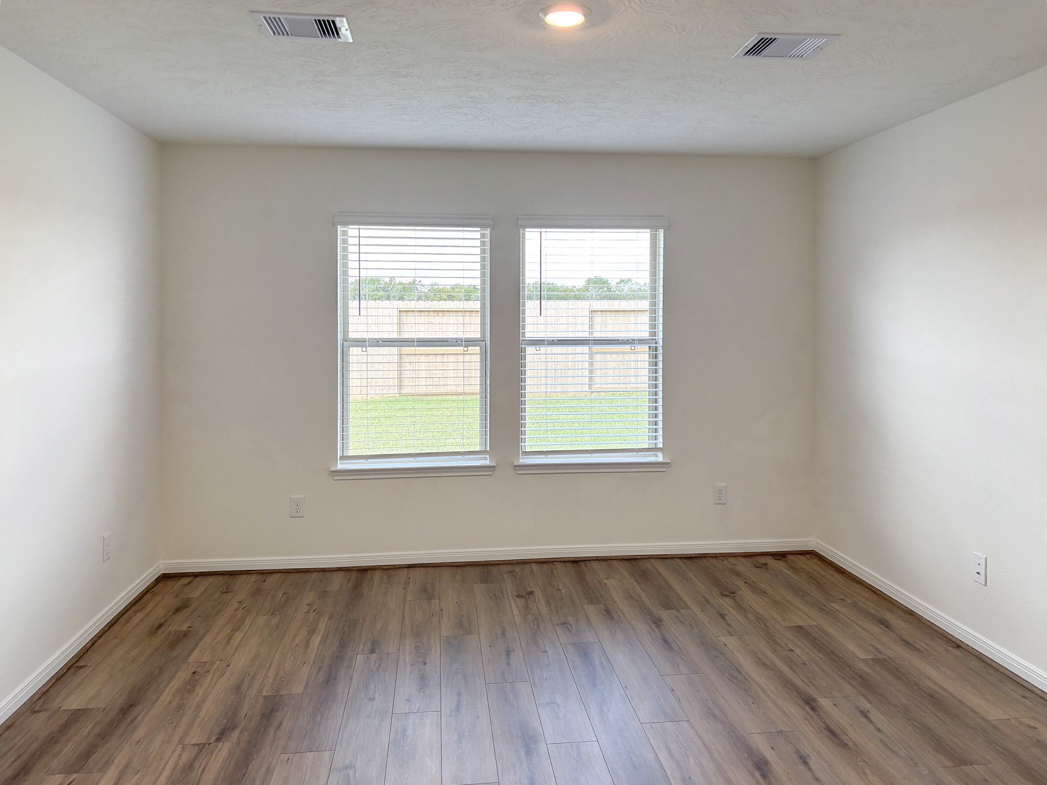 The primary bedroom is located at the rear of the home and away from the other bedrooms for extra privacy.
