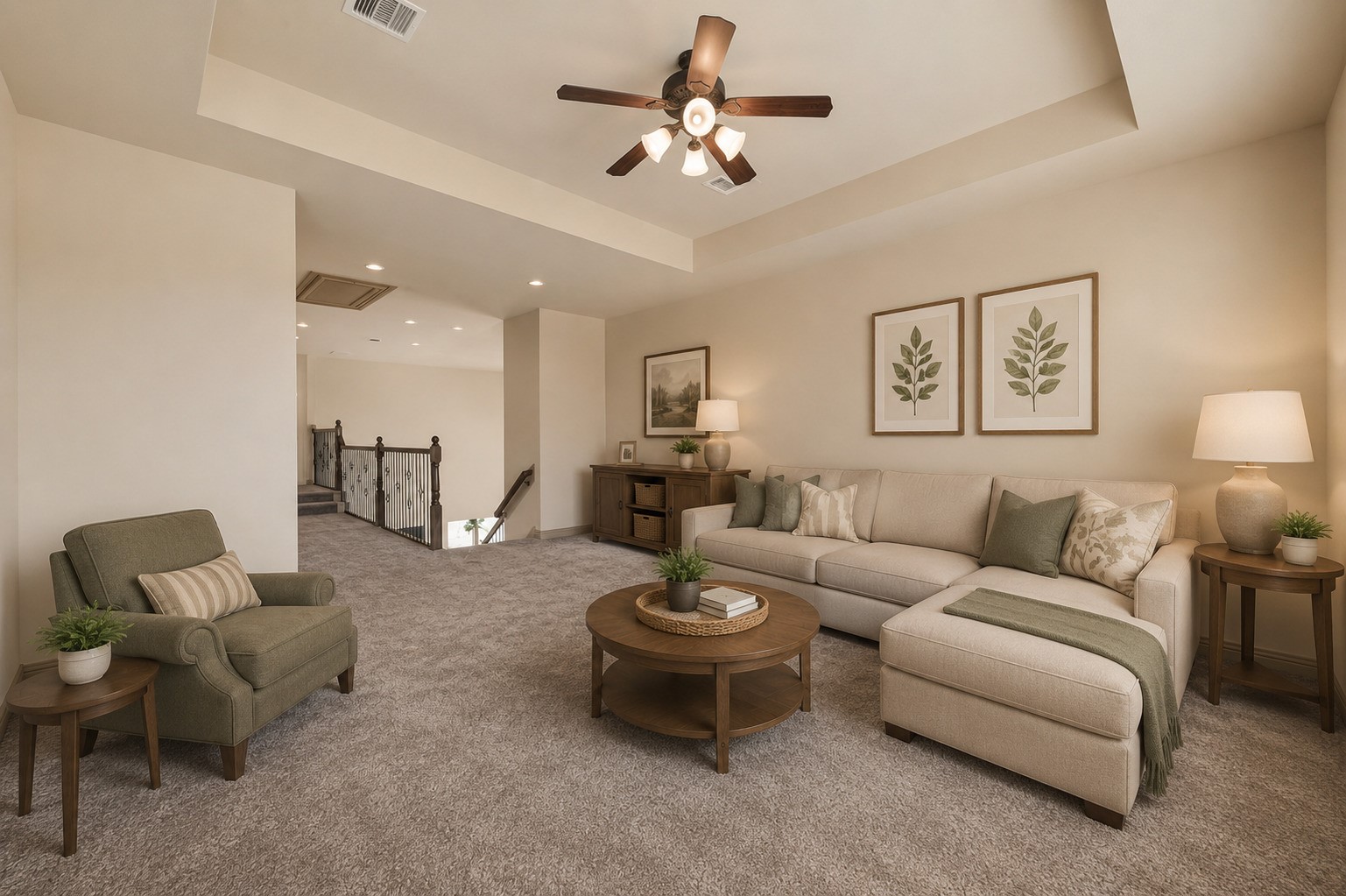 From this angle, the upstairs sitting area reveals its generous proportions and open connection to the staircase landing. Carpeted for comfort with recessed lighting and a ceiling fan, this flexible space is perfect for a game room, lounge, or gathering area for loved ones. (Virtually staged)