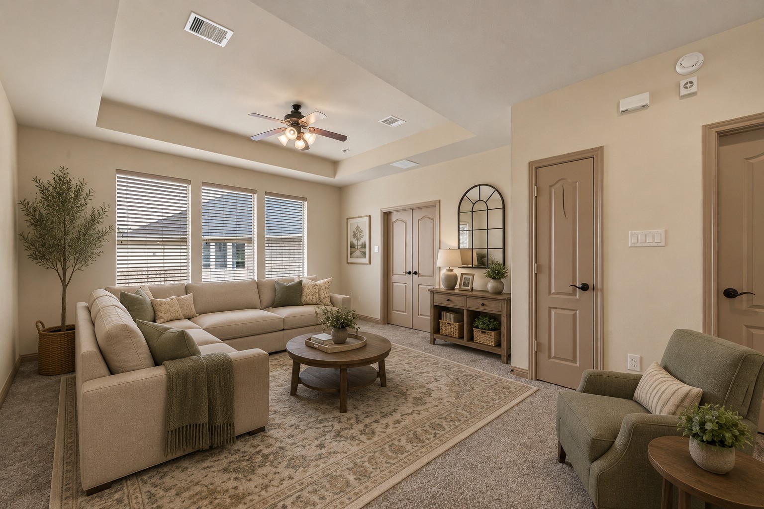 This versatile sitting area features a tray ceiling with a ceiling fan, plush carpeting, and large windows that fill the space with natural light. Double doors provide access to additional rooms, making it an ideal secondary living space, media room, or relaxation retreat. (Virtually staged)