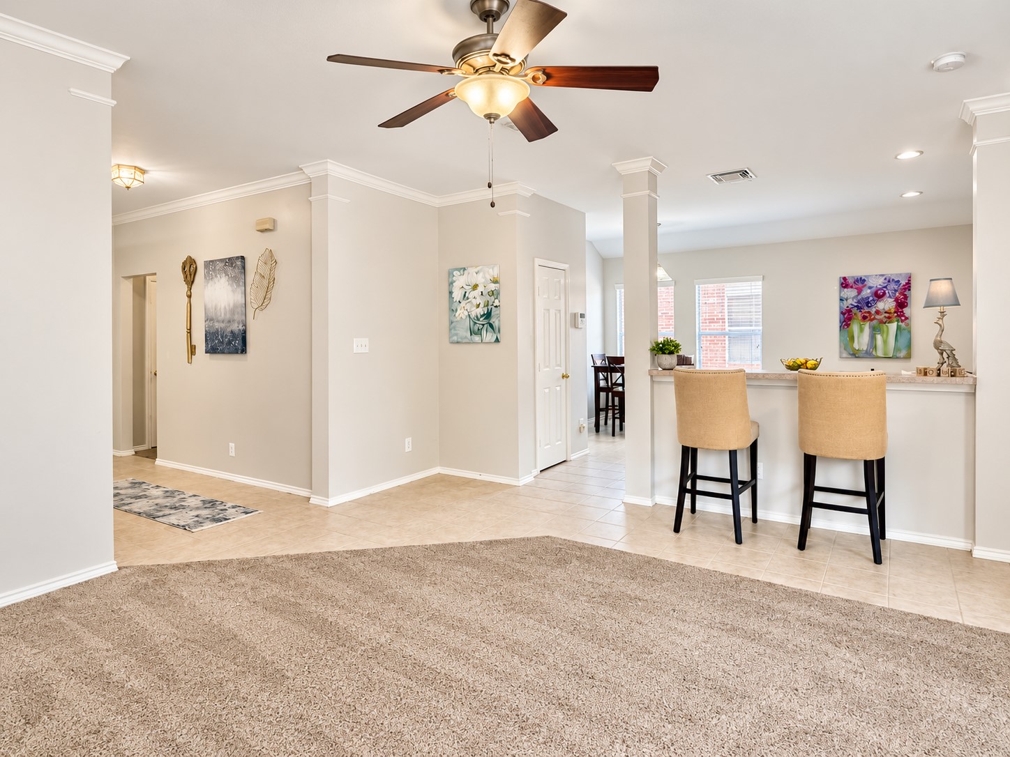 This picture shows part of the family room leading in from the entry way.  This shows partially the breakfast area.