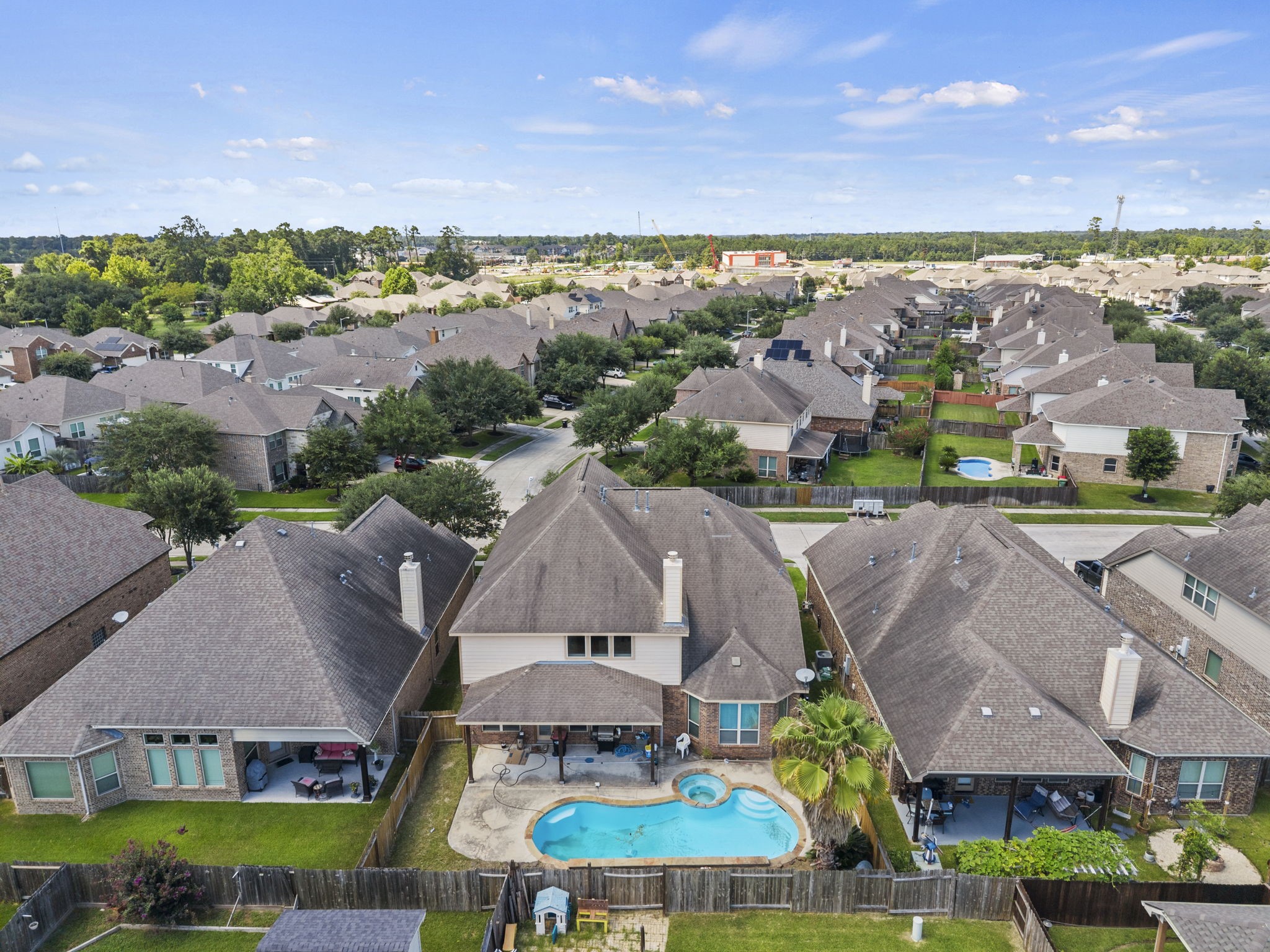 Backyard paradise awaits with a stunning freeform pool, spa, and covered patio, your own private retreat overlooking a sprawling, tree-filled community!