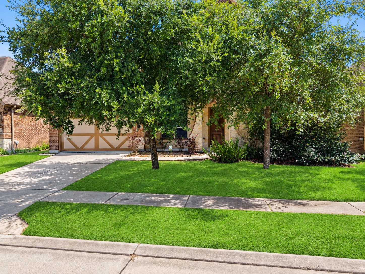 Mature shade trees frame a stately entry and freshly manicured lawn, pure curb appeal from the moment you arrive!