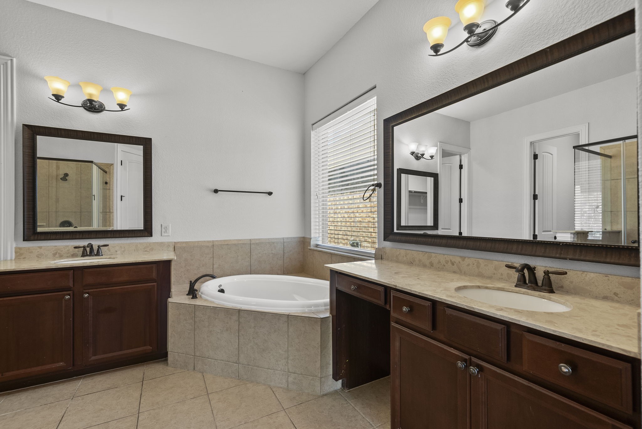 Luxurious ensuite bath indulges with dual vanities, a relaxing soaking tub, and elegant designer finishes throughout, a true spa-inspired retreat!