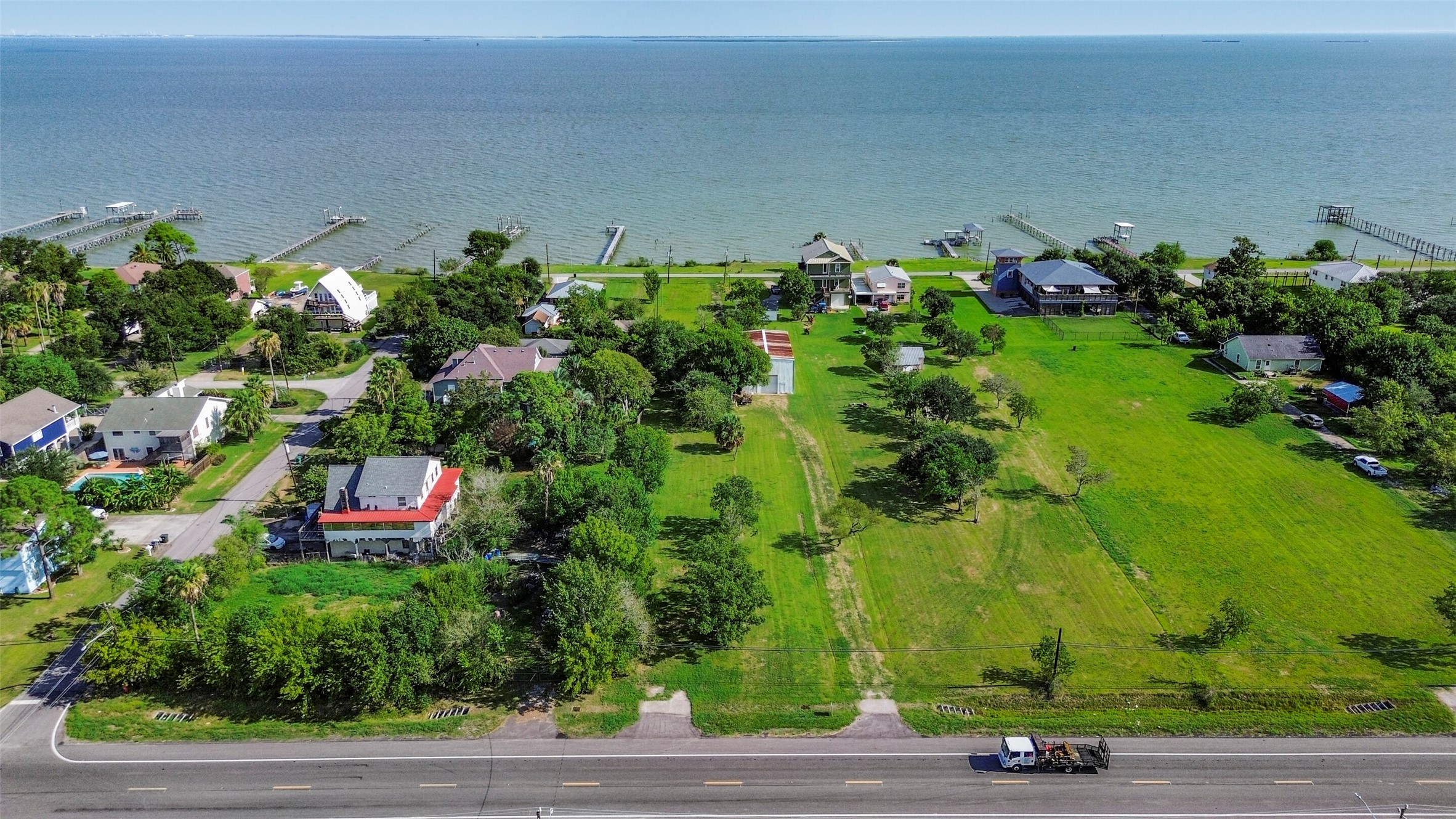 Expansive waterfront property with lush greenery, offering stunning bay views and access to private piers. Ideal for those seeking a serene coastal lifestyle.